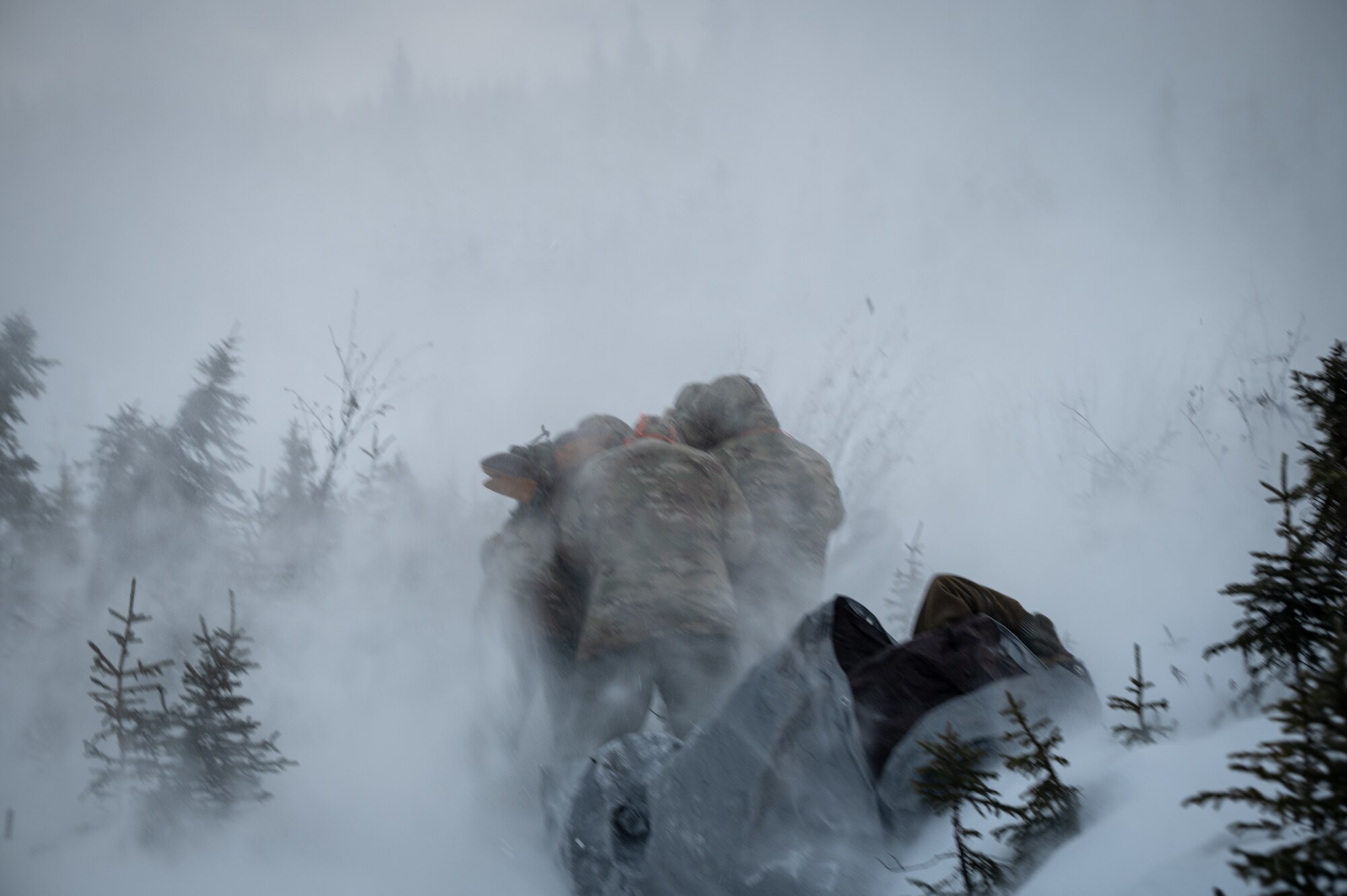 U.S. Air Force Arctic Survival Training students experience a rotor wash during a helicopter recovery exercise on Eielson Air Force Base, Alaska, Nov. 18, 2021.