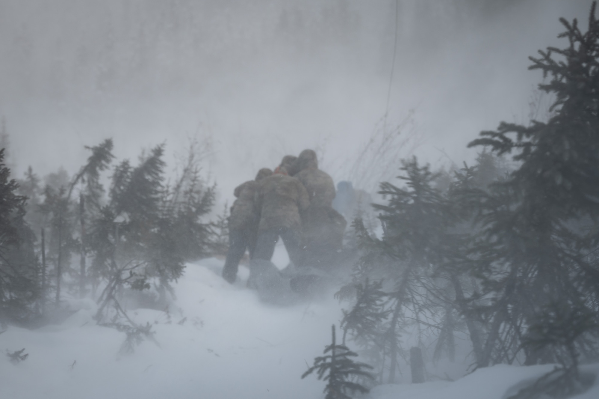 U.S. Air Force Arctic Survival Training students experience a rotor wash during a helicopter recovery exercise on Eielson Air Force Base, Alaska, Nov. 18, 2021.