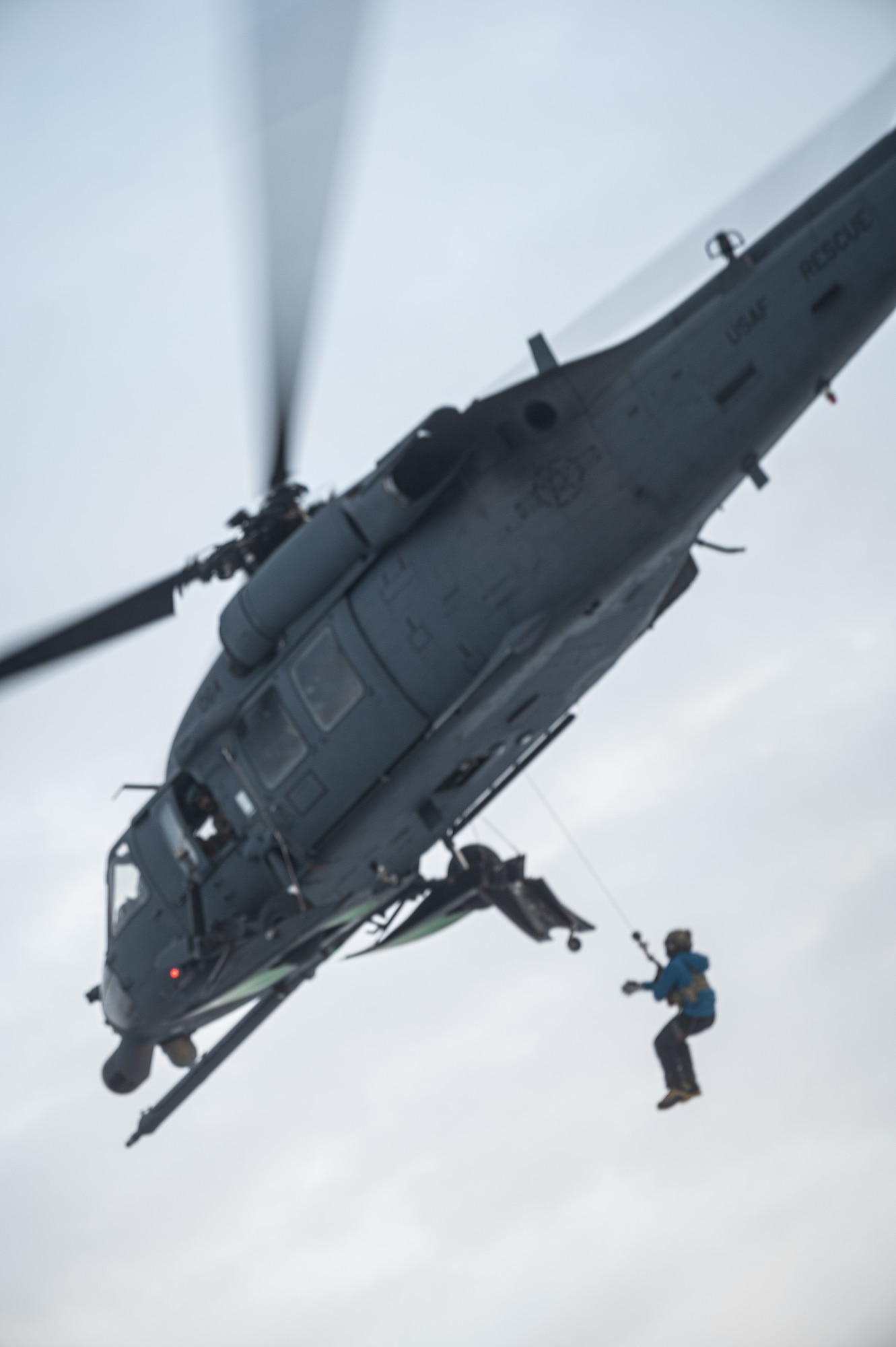A U.S. Air Force pararescueman assigned to the 210th Rescue Squadron gets hoisted during a recovery exercise on Eielson Air Force Base, Alaska, Nov. 18, 2021.