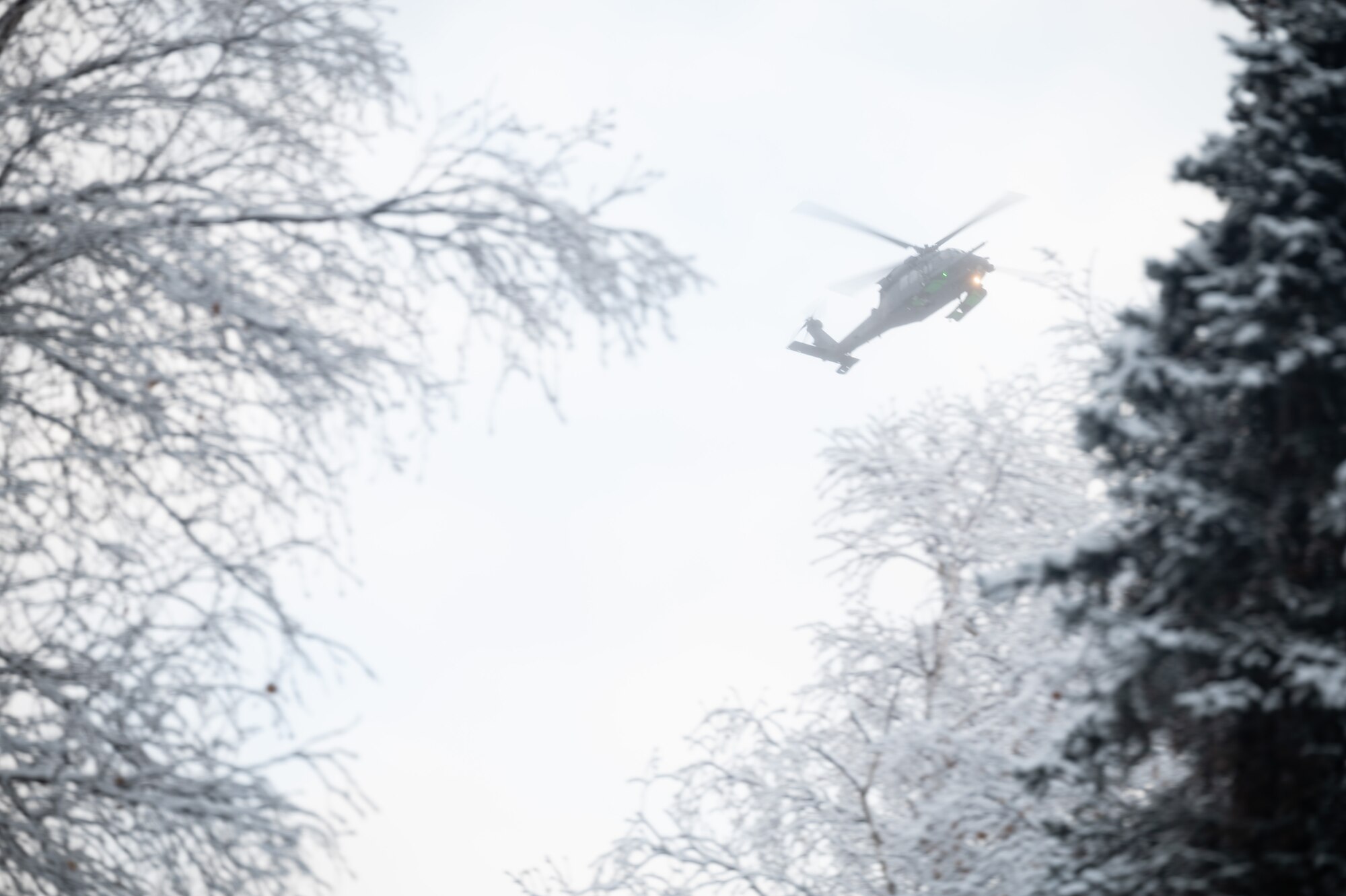 A U.S. Air Force HH-60G Pavehawk helicopter assigned to the Alaska National Guard hovers over Eielson Air Force Base, Alaska during a recovery exercise, Nov. 18, 2021.