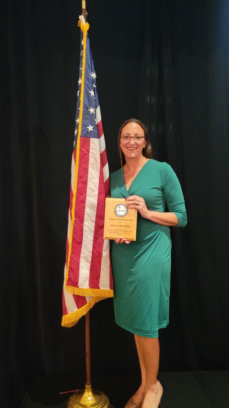Photo of Natalie Yacoub-Pugh receiving the Champion of Veterans Enterprise Award.
