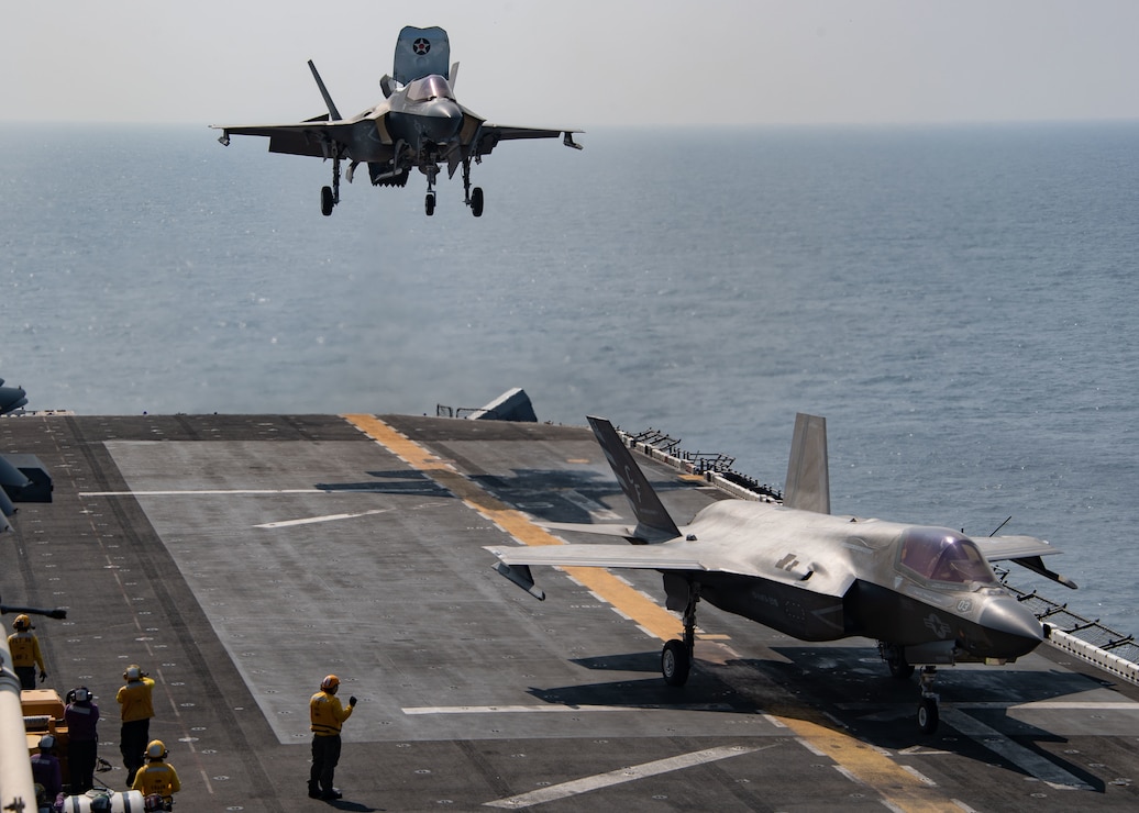 F-35B Lightning II attached to Marine Fighter Attack Squadron (VMFA) 211, deployed with the British Royal Navy aircraft carrier HMS Queen Elizabeth, lands on the flight deck of the amphibious assault ship USS Essex (LHD 2) during an interoperability exercise with Queen Elizabeth,