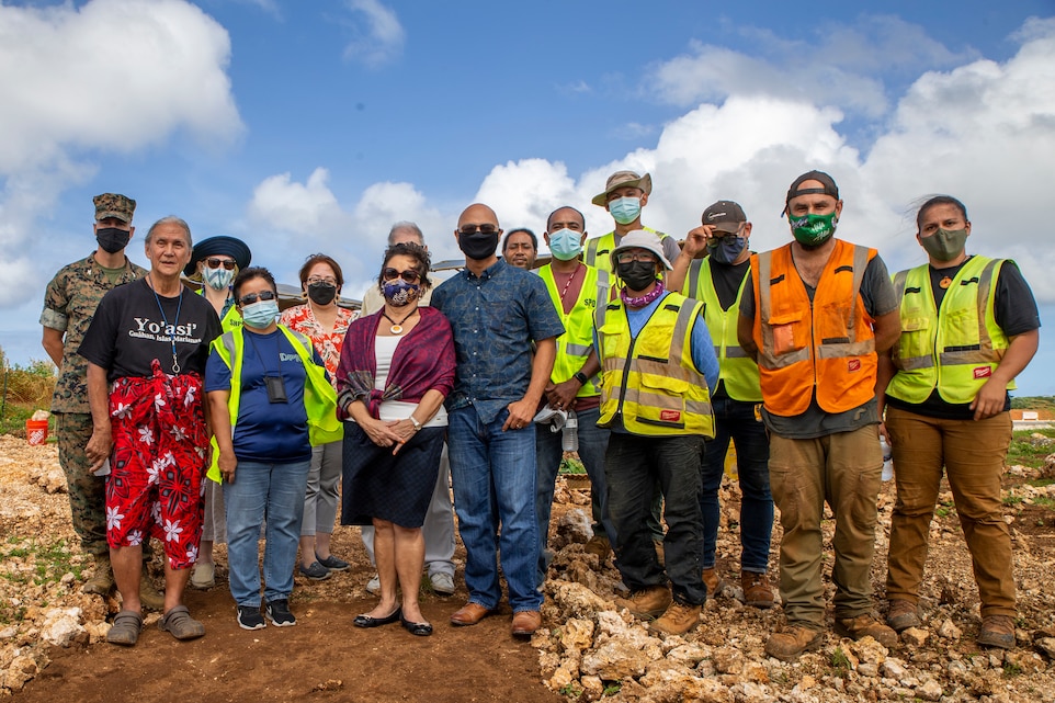 U.S. Marine Corps Col. Christopher Bopp, the Marine Corps Base Camp Blaz commanding officer, left, poses for a photograph with Government of Guam officials and archaeologists with Naval Facilities Engineering Systems Command Marianas during a cultural ritual at the Sabånan Fadang burial site on MCB Camp Blaz, Nov. 23, 2021. The burial site includes seven grave pits comprised of multiple individuals, with the final overall number of individuals still pending analysis. The ritual is the first of its kind as the ceremonies are typically held later, as required under Guam law, when monuments are erected for reburial ceremonies.