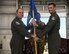 Pictured above are two Airmen posing for a photo holding a flag.