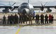 Pictured above is a group of people standing in front of an aircraft.