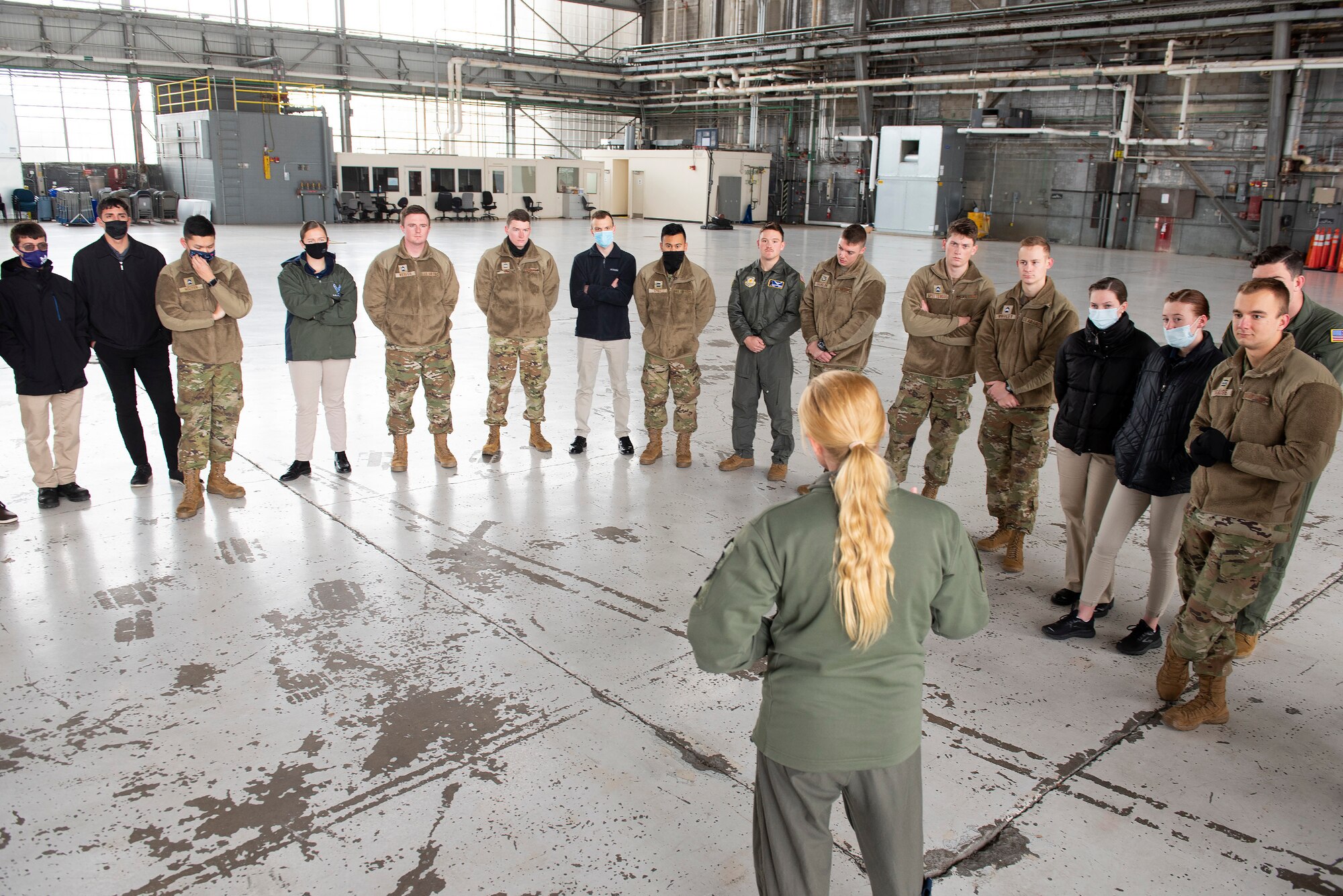 Maj. Sarah Kociuba, 393rd Bomb Squadron pilot, visits with Air Force ROTC cadets of Detachment 643 on Nov. 15, 2021, in a hangar at Wright-Patterson Air Force Base, Ohio. The University of Dayton alum came back to Wright-Patt to talk with students from her old ROTC unit about the transition from cadet to Air Force officer. (U.S. Air Force photo by R.J. Oriez)