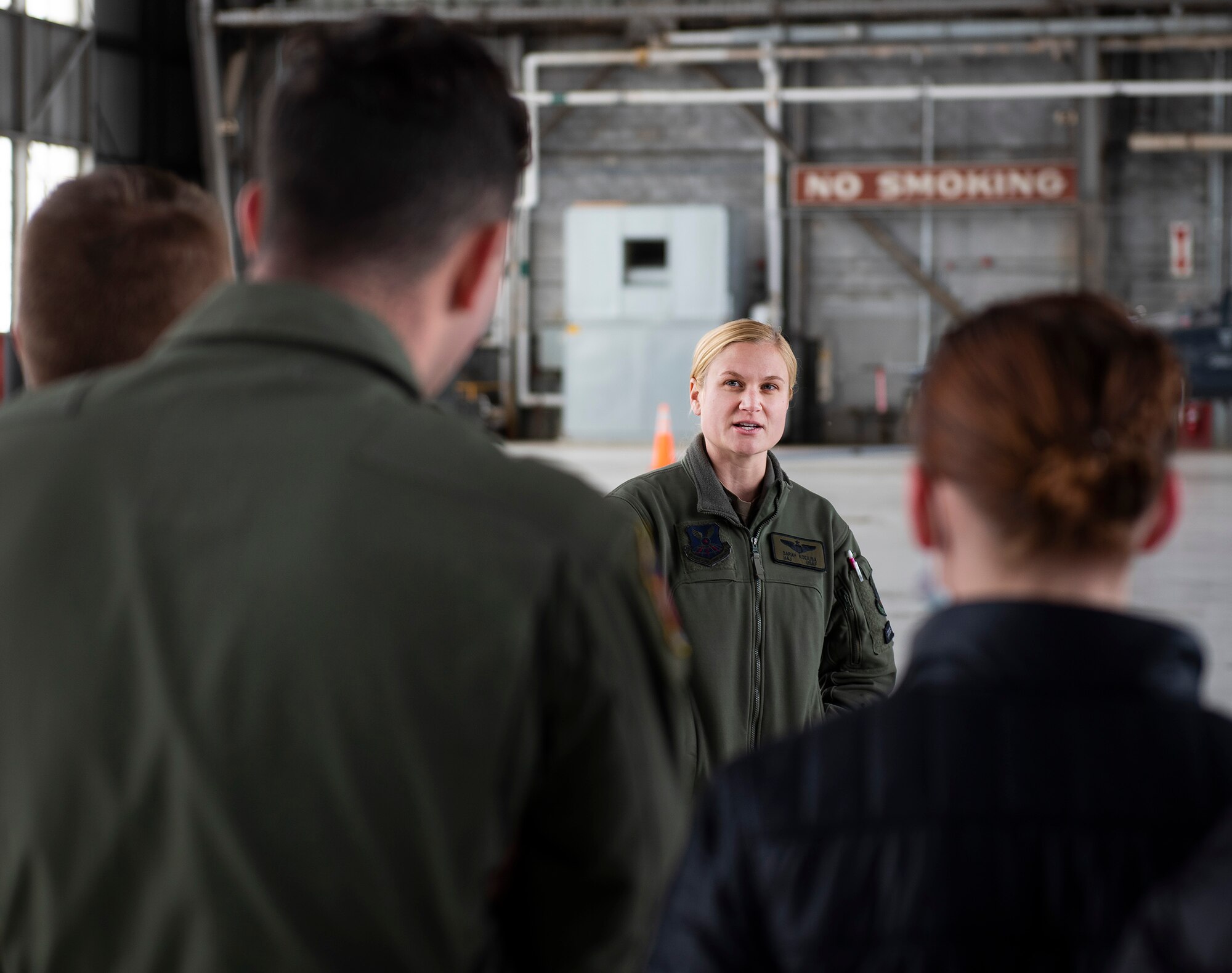 Maj. Sarah Kociuba, 393rd Bomb Squadron pilot, visits with Air Force ROTC cadets of Detachment 643 on Nov. 15, 2021, in a hangar at Wright-Patterson Air Force Base, Ohio. The University of Dayton alum came back to Wright-Patt to talk with students from her old ROTC unit about the transition from cadet to Air Force officer. (U.S. Air Force photo by R.J. Oriez)