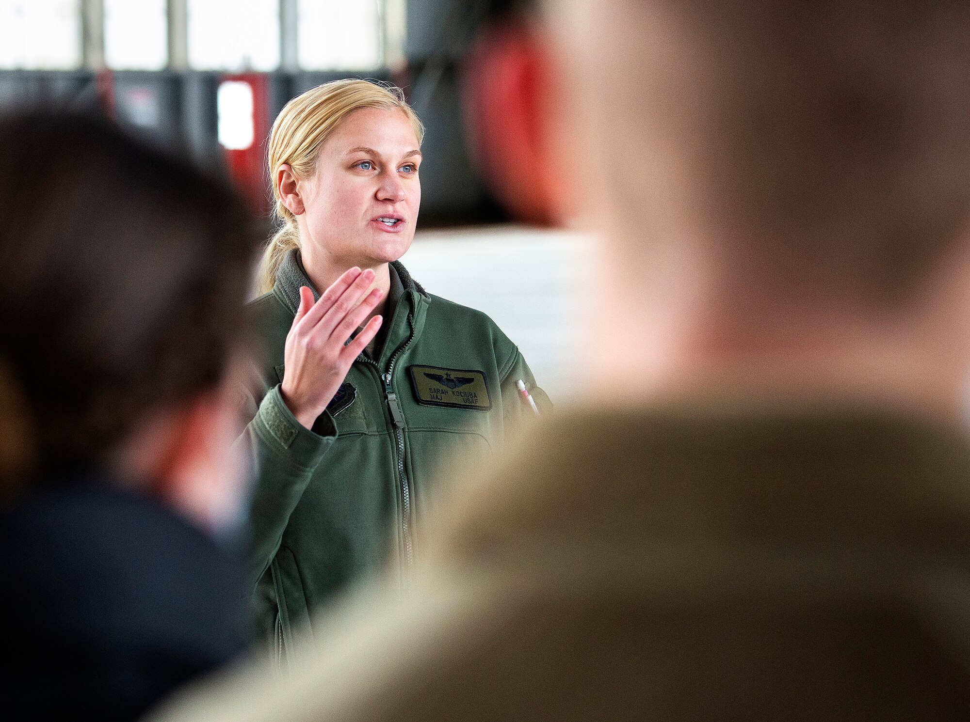 Maj. Sarah Kociuba, 393rd Bomb Squadron pilot, visits with Air Force ROTC cadets of Detachment 643 on Nov. 15, 2021, in a hangar at Wright-Patterson Air Force Base, Ohio. The University of Dayton alum came back to Wright-Patt to talk with students from her old ROTC unit about the transition from cadet to Air Force officer. (U.S. Air Force photo by R.J. Oriez)