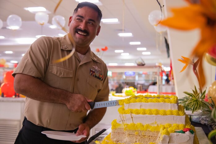 A U.S. Navy Corpsman cuts into a Marine Corps birthday cake at Anderson Chow Hall, Marine Corps Base Hawaii, Nov. 10, 2021. Employees at the Anderson Chow Hall held a birthday lunch celebrating the 246th U.S. Marine Corps Birthday. (U.S. Marine Corps photo by Lance Cpl. Christian Tofteroo)
