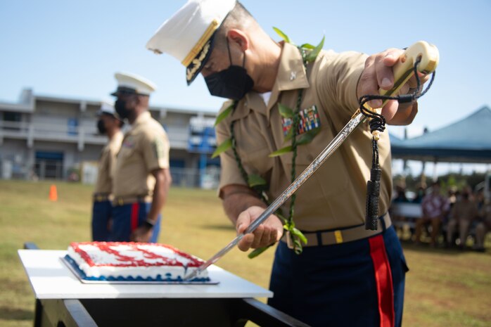 U.S. Marine Corps Col. Speros Koumparakis, commanding officer, Marine Corps Base Hawaii, uses a Mameluke sword to slice a cake during a Marine Corps Birthday ceremony at Kalaheo High School, Kailua, Hawaii, Nov. 17, 2021. The ceremony was held in an effort to share the Marine Corps Birthday tradition and engage with the local community. (U.S. Marine Corps photo by Cpl. Brandon Aultman)