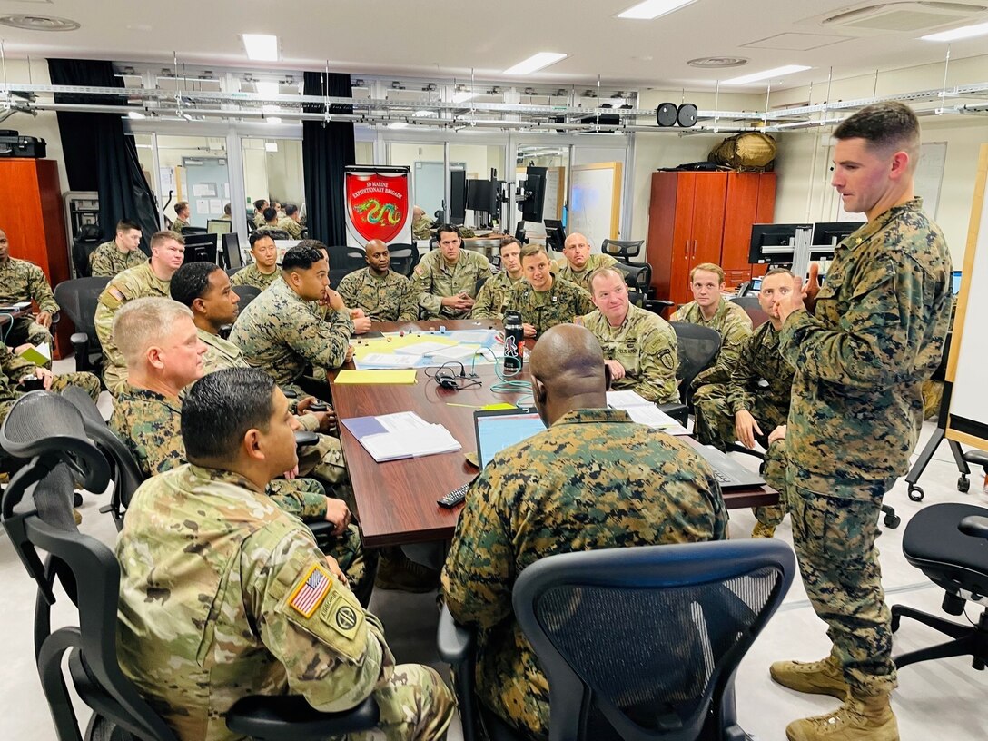 U.S. Marine Corps Maj. Alex Butta, Future Operations Planner, 3rd Marine Expeditionary Brigade, briefs members with Maneuver Advisor Team 5310, Force Package 22-1, 5th Security Force Assistance Brigade, as well as other MEB planning staff aboard Camp Courtney, in Okinawa, Japan, Nov. 19, 2021 in preparation for participation in Yama Sakura 81. Yama Sakura 81 is the largest U.S.-Japan bilateral and joint command post exercise which enables participants to work as dedicated partners in support of the Japan-U.S. security alliance and for continued peace and stability in the Indo-Pacific. This year’s exercise commemorates the 40th anniversary of Yama Sakura. (Photo by U.S. Marine Corps Lt. Col. Caleb Eames)