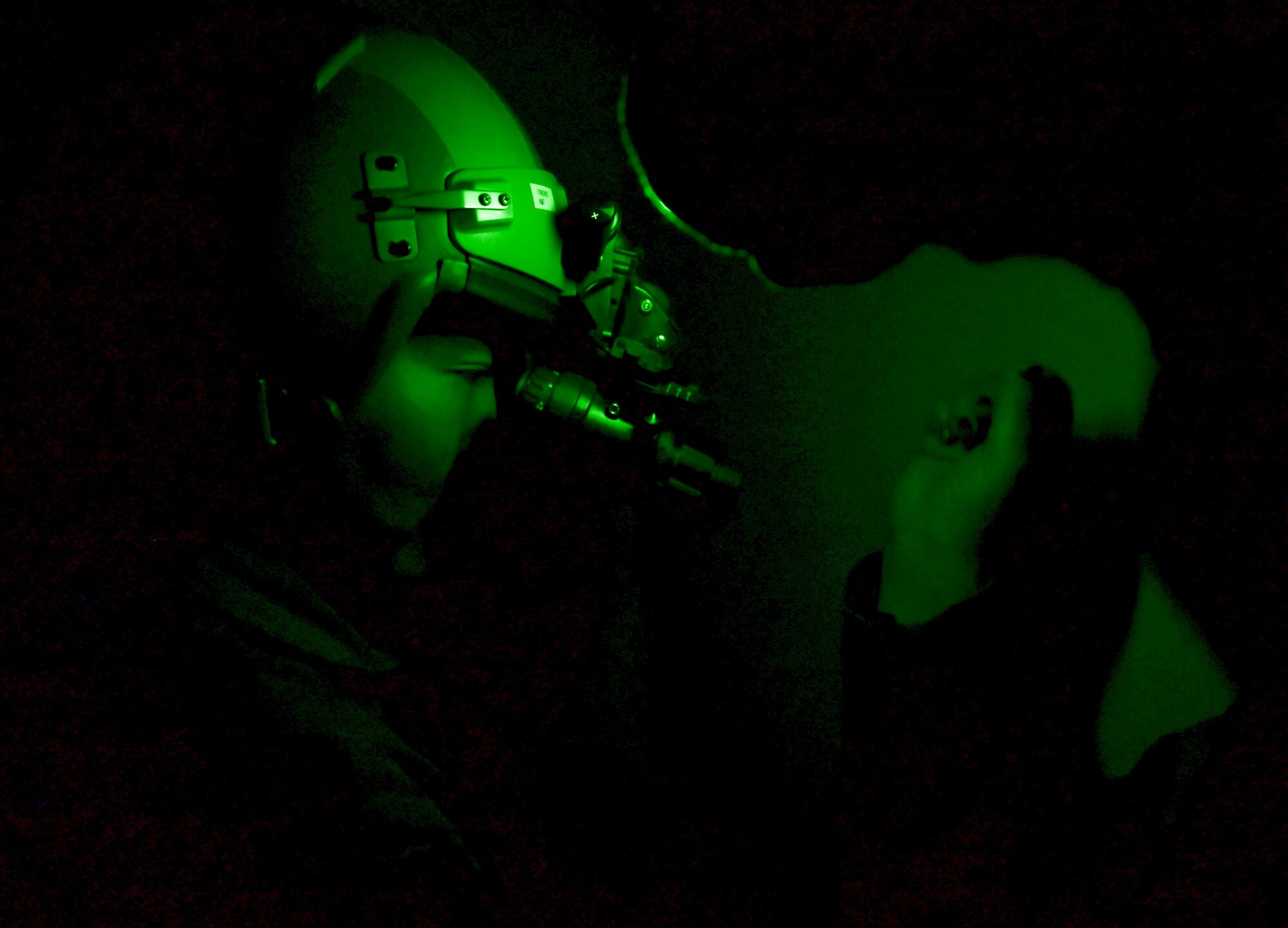 Staff Sgt. Elissa Black, 80th Fighter Squadron noncommissioned officer in charge of aircrew flight equipment, assists a pilot with their flight helmet at Kunsan Air Base, Republic of Korea, Nov. 3, 2021. The 8th Fighter Wing pilots depend on Aircrew Flight Equipment Airmen to have attention to detail when handling survival kits, parachutes, maintaining oxygen masks and flight helmets that can mean the difference between life and death. (U.S. Air Force photo by Staff Sgt. Jesenia Landaverde)
