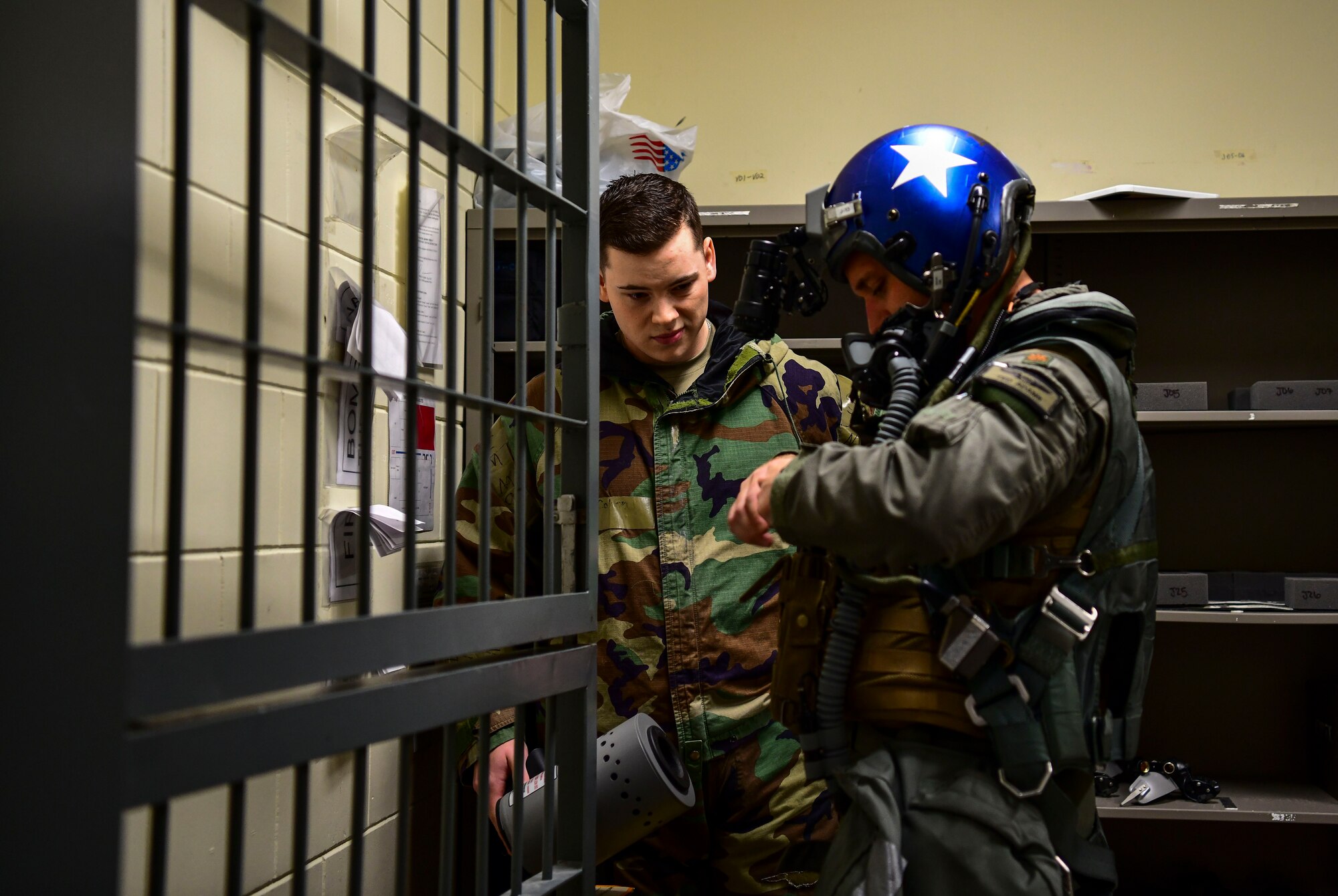 Senior Airman Colton Knight, 80th Fighter Squadron aircrew flight equipment technician, arms F-16 Fighting Falcon pilot before flight at Kunsan Air Base, Republic of Korea, Nov. 3, 2021. The 8th Fighter Wing pilots depend on Aircrew Flight Equipment Airmen to have attention to detail when handling survival kits, parachutes, maintaining oxygen masks and flight helmets that can mean the difference between life and death. (U.S. Air Force photo by Staff Sgt. Jesenia Landaverde)