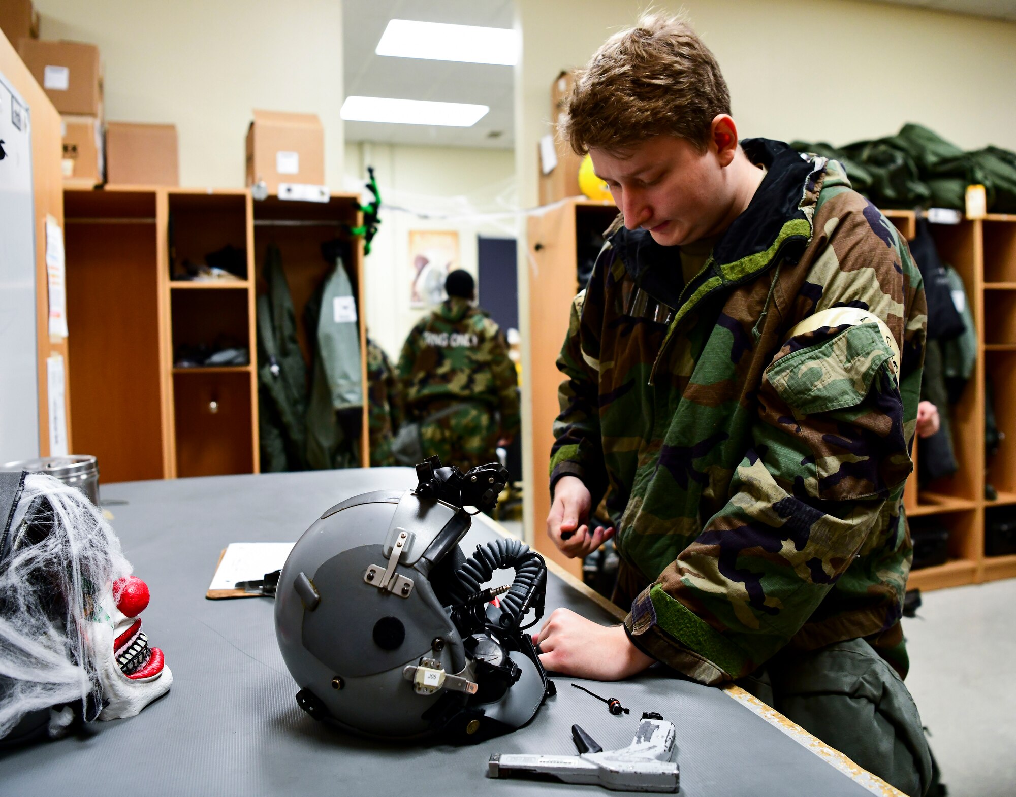 Captain (Doctor) Lisa Choe, 80th Fighter Squadron flight doctor, tests HGU 55-P flight helmet for night vision at Kunsan Air Base, Republic of Korea, Nov. 3, 2021. The 8th Fighter Wing pilots depend on Aircrew Flight Equipment Airmen to have attention to detail when handling survival kits, parachutes, maintaining oxygen masks and flight helmets that can mean the difference between life and death. (U.S. Air Force photo by Staff Sgt. Jesenia Landaverde)