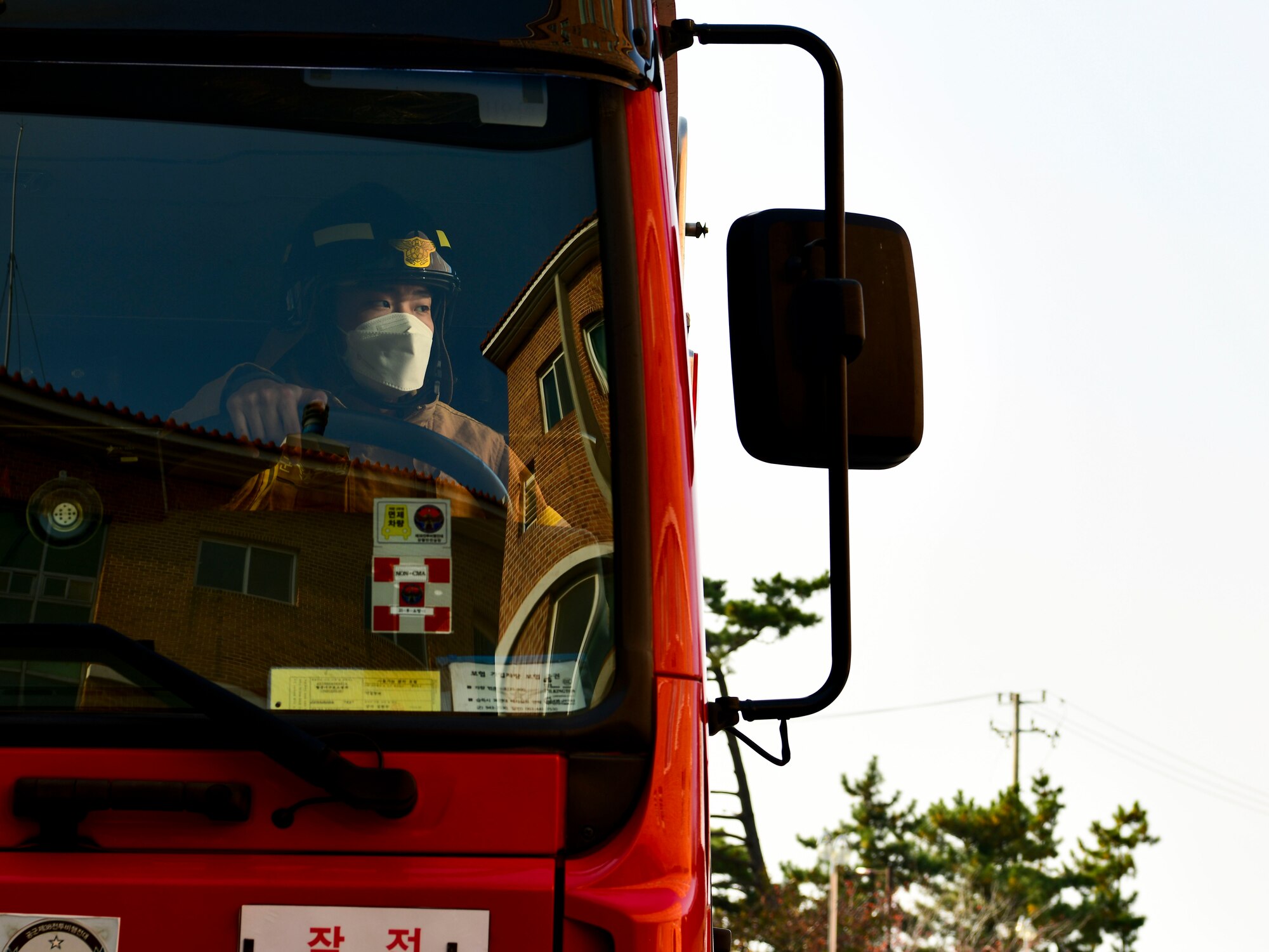 A Republic of Korea Air Force firefighter parks firetruck when arriving to a structural fire at Kunsan Air Base, R.O.K., Nov. 4, 2021. Both 8th Fighter Wing and 38th Fighter Group firefighters were tested in their ability to respond quickly to a simulated structural fire on base. (U.S. Air Force photo by Staff Sgt. Jesenia Landaverde)