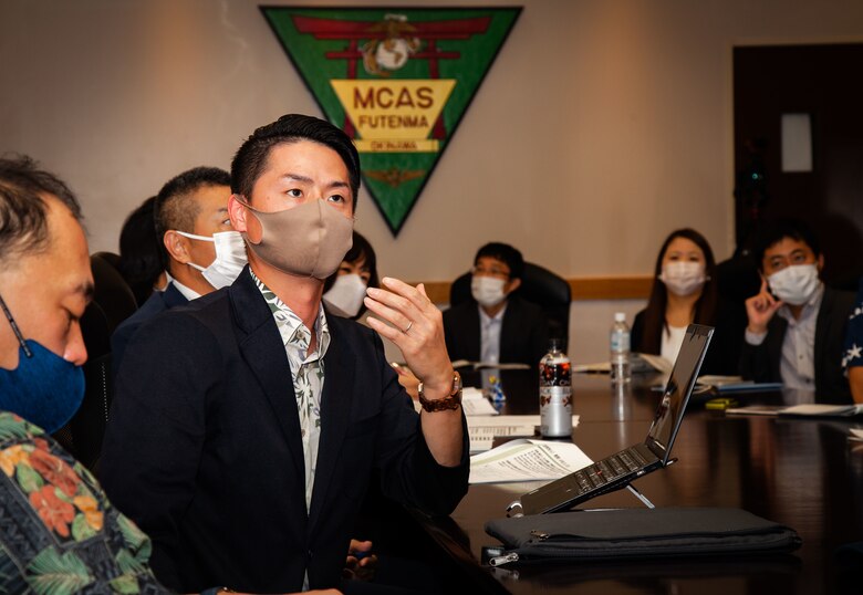 Business professionals from Global Tekijuku Business School attend the Marine Corps 101 briefing at Marine Corp Air Station Futenma, Okinawa, Japan, on Nov. 18, 2021. Col. Neil Owens, assistant chief of staff, government and external affairs (G-7), Marine Corps Installations Pacific, conducted a brief to inform business professionals from Global Tekijuku Business School on national security issues and the United States and Japan alliance. (U.S. Marine Corps photo by Sgt. Kayla V. Staten)