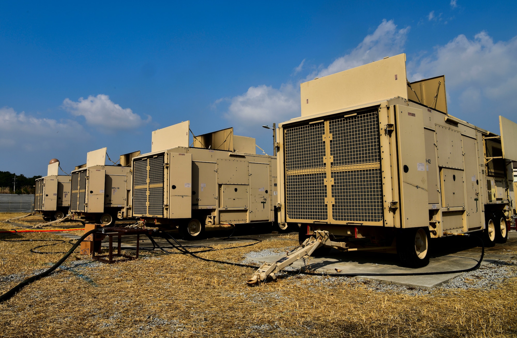 Four bare power unit (BPU) high voltage generators provide power to the installation at Kunsan Air Base, Republic of Korea, Nov. 4, 2021. The 8th Civil Engineer Squadron electrical power production unit and 8th Logistics Readiness Squadron fuels flight test their ability to provide power to the base with BPUs, which run on fuel. (U.S. Air Force photo by Staff Sgt. Jesenia Landaverde)