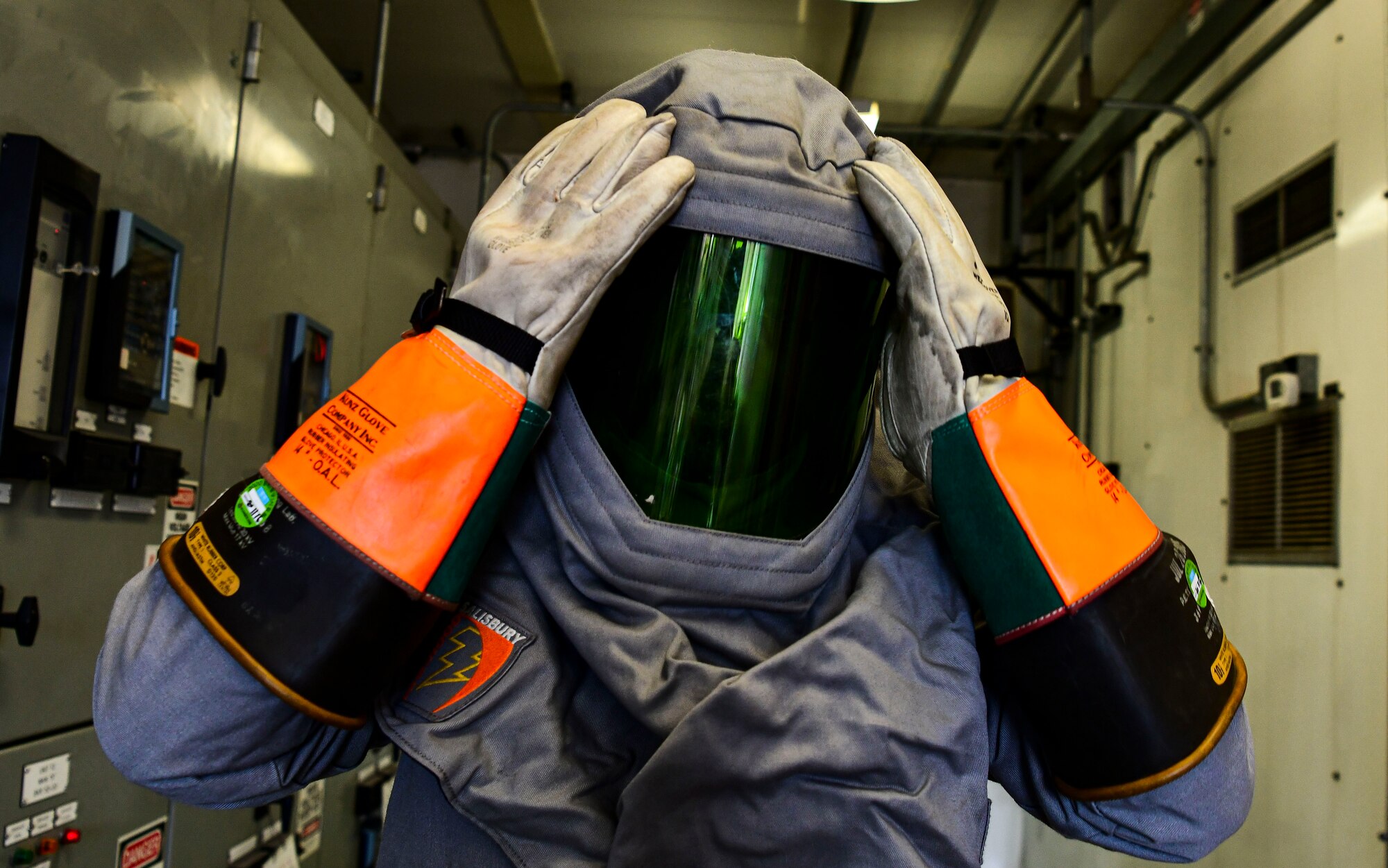 Staff Sgt. Patrick Smith, 8th Civil Engineer Squadron electrical systems technician, dons electrical safety gear at Kunsan Air Base, Republic of Korea, Nov. 4, 2021. The 8th CES electrical power production unit and 8th Logistics Readiness Squadron fuels flight test their ability to provide power to the base with BPUs, which run on fuel. (U.S. Air Force photo by Staff Sgt. Jesenia Landaverde)
