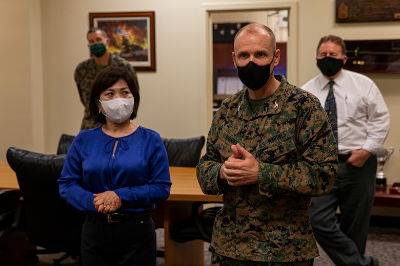 U.S. Marine Corps Col. Douglas Burke, camp commander of Camp Kinser and the commanding officer of Combat Logistics Regiment 37, 3rd Marine Logistics Group, greets students with Okinawa International University before they begin a tour on Camp Kinser, Okinawa, Japan, Nov. 22, 2021. For the first time since the COVID-19 pandemic began, students with Okinawa International University were able to visit Camp Kinser and participate in a guided tour of the base. The tour included a question and answer interactive class between the students and Marines, a visit to the Battle of Okinawa Historical Display, lunch at the Camp Kinser Mess Hall, and was followed by a walkthrough of Marines’ living quarters. (U.S. Marine Corps photo by Lance Cpl. Alex Fairchild)