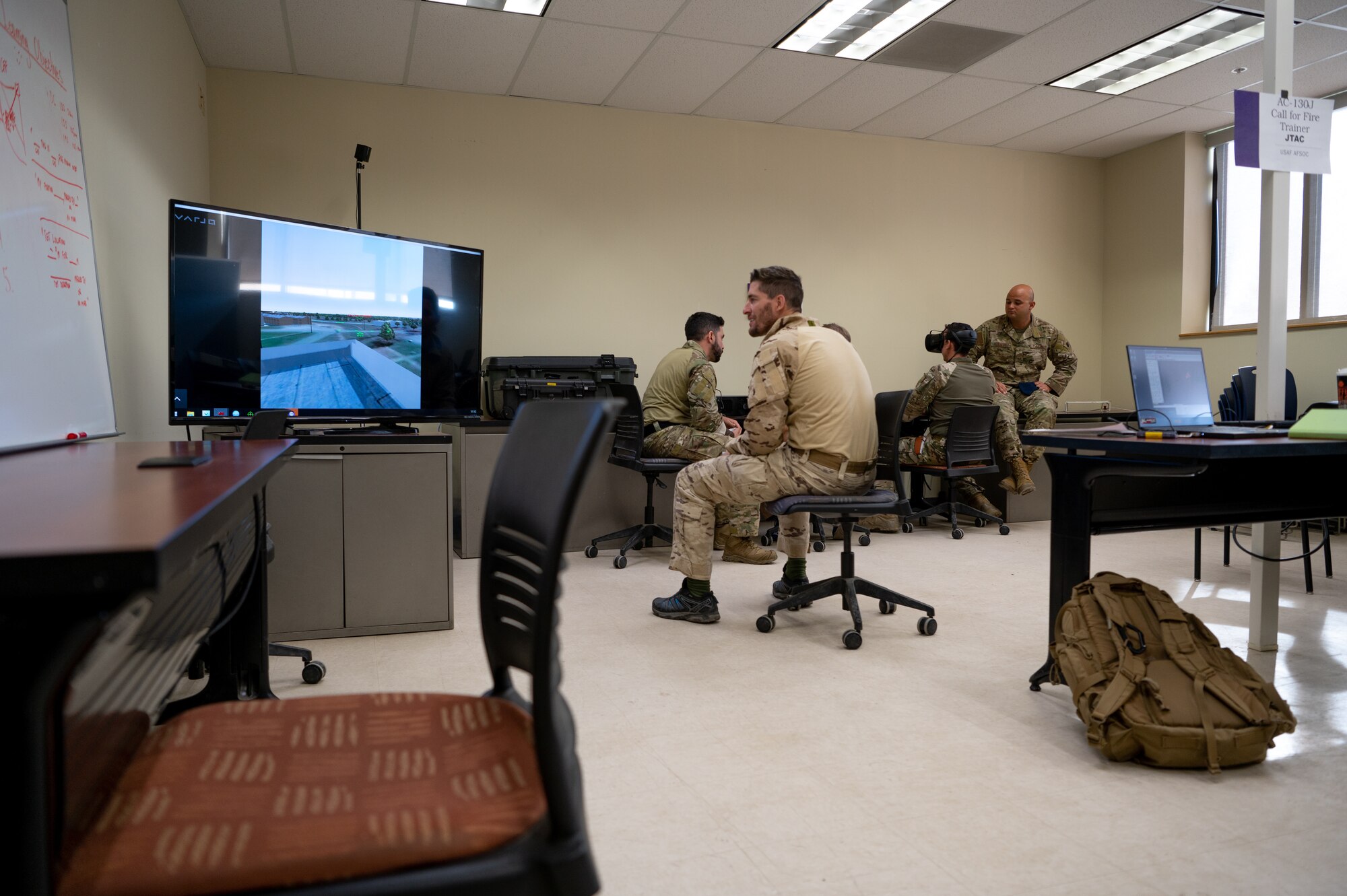 U.S. Air Force Technical Sgt. Edward Newberrn, 23rd Special Tactics Squadron combat controller, evaluates joint terminal attack controllers from Spain on a virtual reality simulator during Bold Quest 21.2 at Muscatatuck Urban Training Center Nov. 6, 2021. Newbernn walked through training scenarios and how to work with AC-130J Ghostrider aircraft and then gave tips on how to communicate effectively. (U.S. Air Force photo by Staff Sgt. Rito Smith)