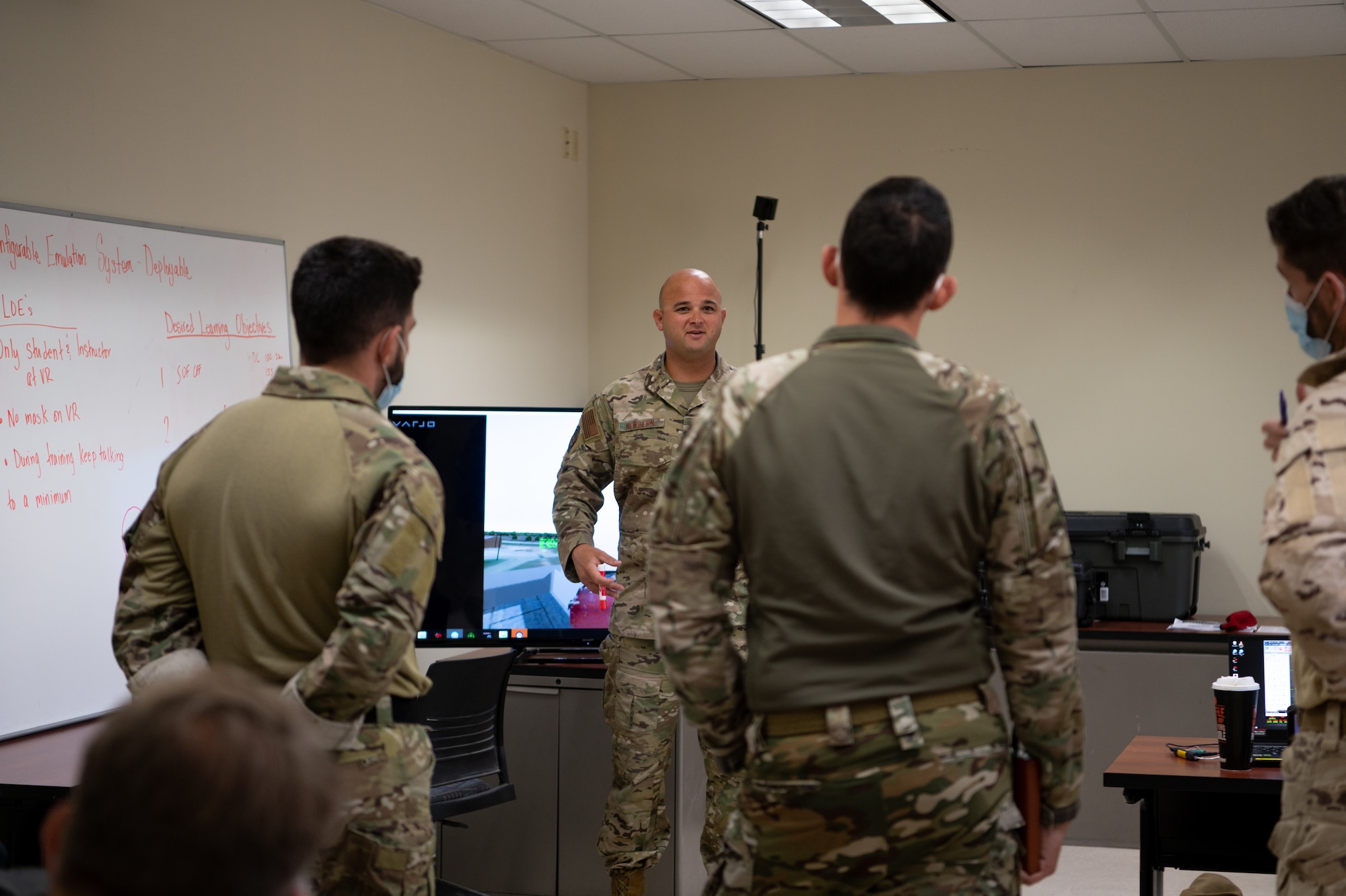 U.S. Air Force Technical Sgt. Edward Newberrn, 23rd Special Tactics Squadron combat controller, briefs Spanish Air Force (Ejército del Aire) joint terminal attack controllers during Bold Quest 21.2 at Muscatatuck Urban Training Center Nov. 6, 2021. Newbernn walked through training scenarios and how to work with AC-130J Ghostrider aircraft. (U.S. Air Force photo by Staff Sgt. Rito Smith)