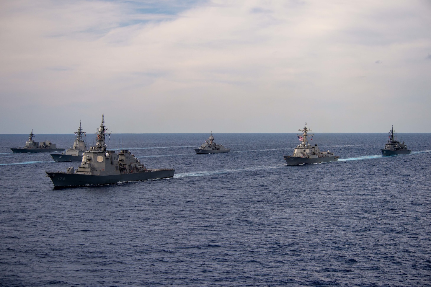 The Japan Maritime Self-Defense Force (JMSDF) Akizuki-class destroyer JS Teruzuki (DD 116), left, and other multinational ships sail in formation during Annual Exercise (ANNUALEX).