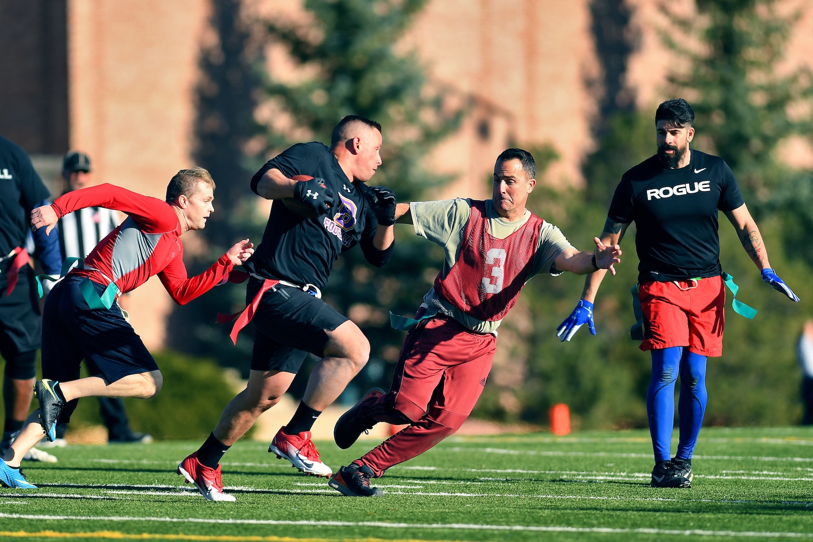 U.S. Space Command and Joint Task Force-Space Defense team members play flag football during inaugural Space Turkey Bowl.