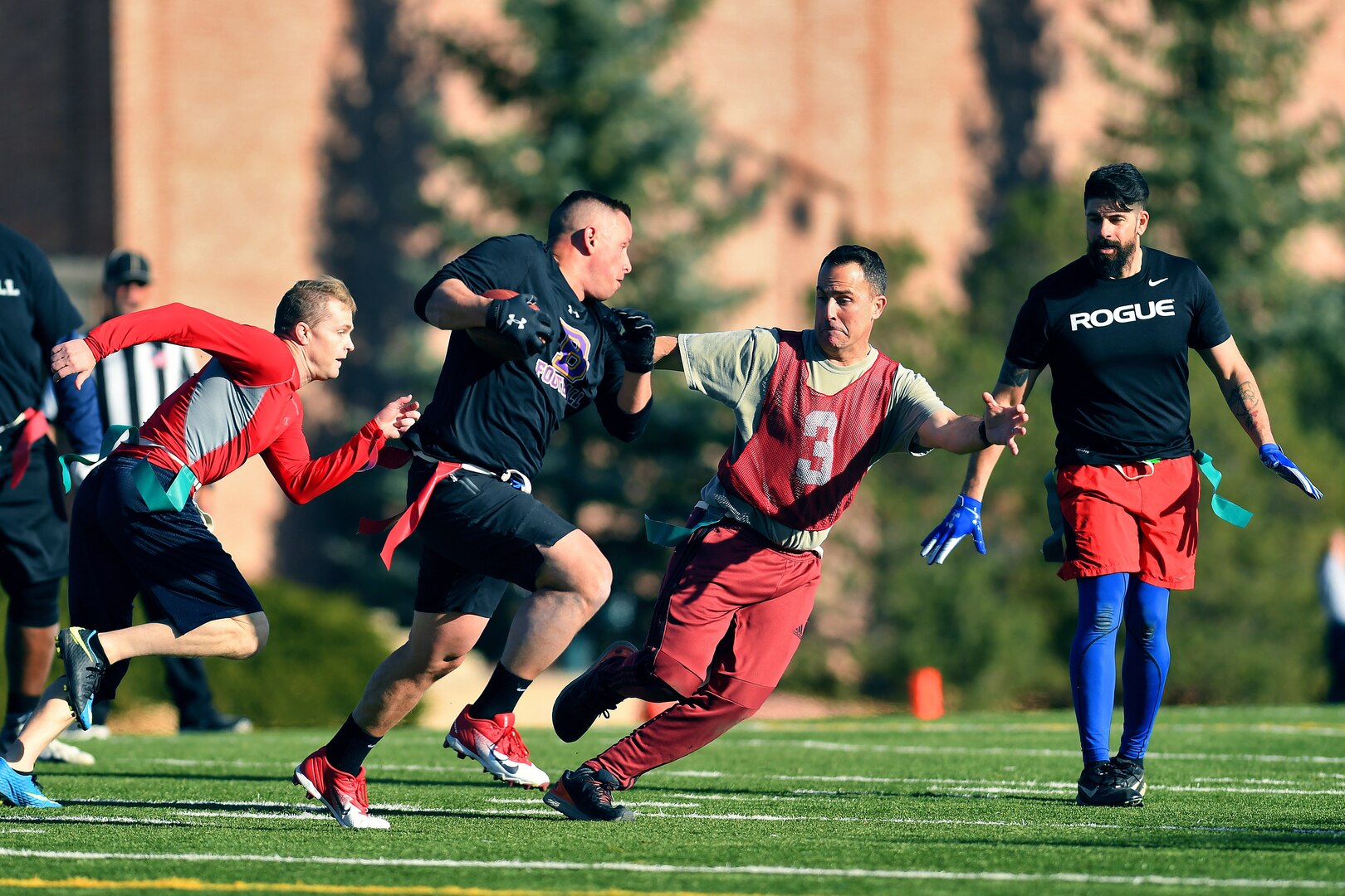 U.S. Space Command and Joint Task Force-Space Defense team members play flag football during inaugural Space Turkey Bowl.