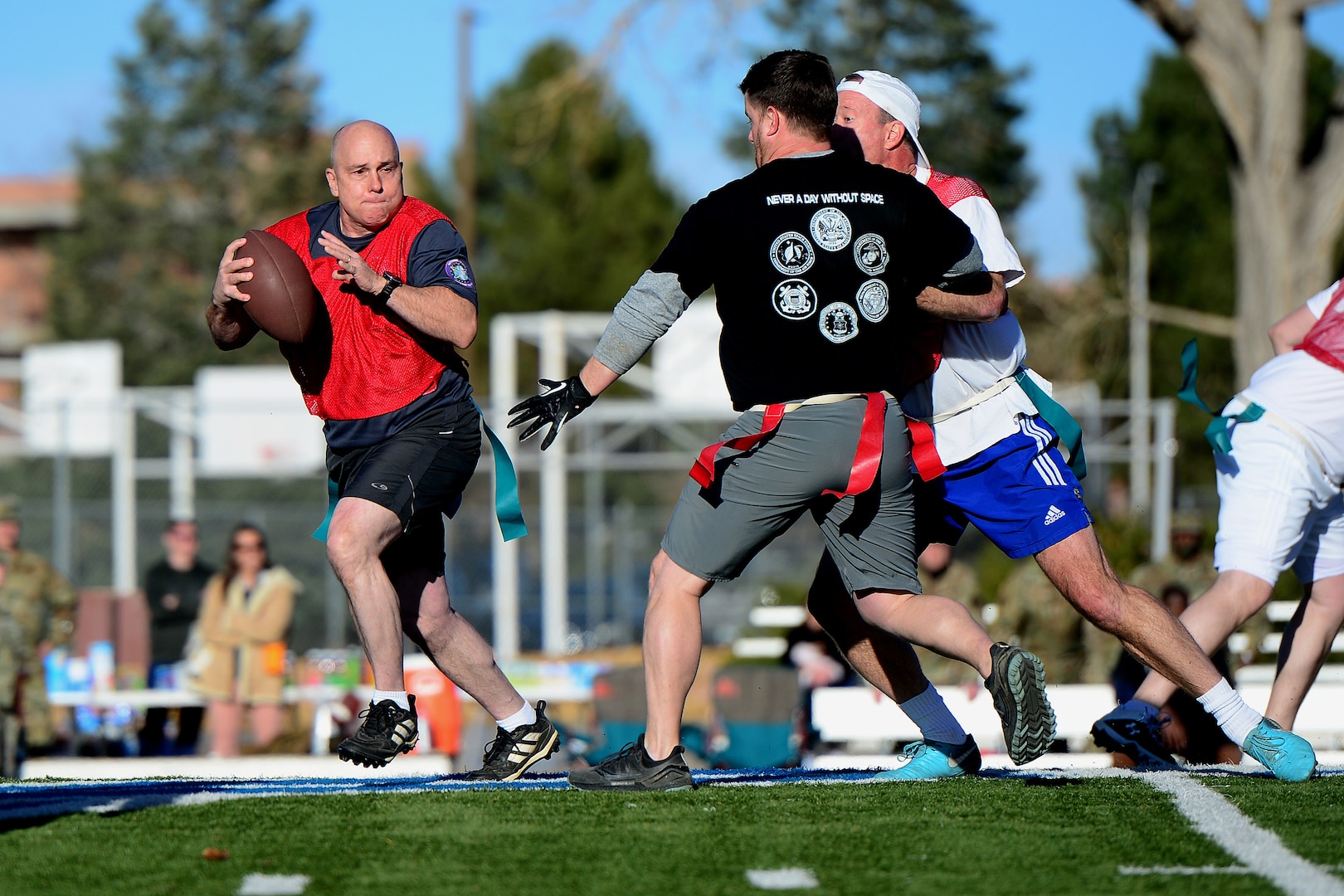 U.S. Space Command and Joint Task Force-Space Defense team members play flag football during inaugural Space Turkey Bowl.