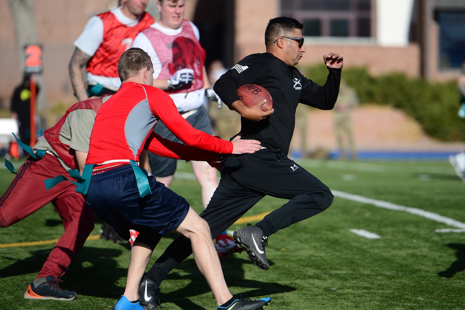 U.S. Space Command and Joint Task Force-Space Defense team members play flag football during inaugural Space Turkey Bowl.