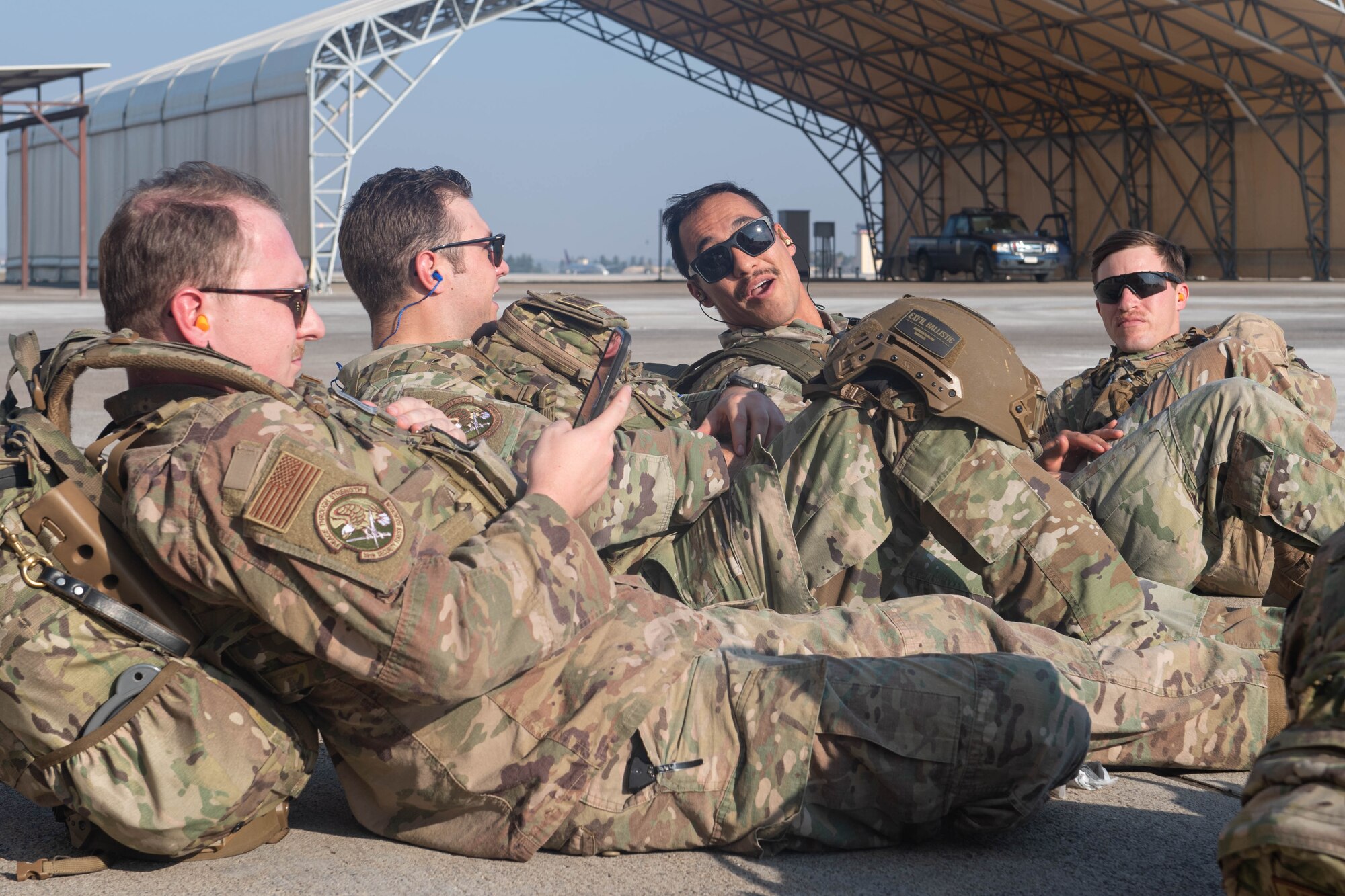 Security forces members talk on the flight line before boarding a UH-60 Black Hawk helicopter during a joint training exercise