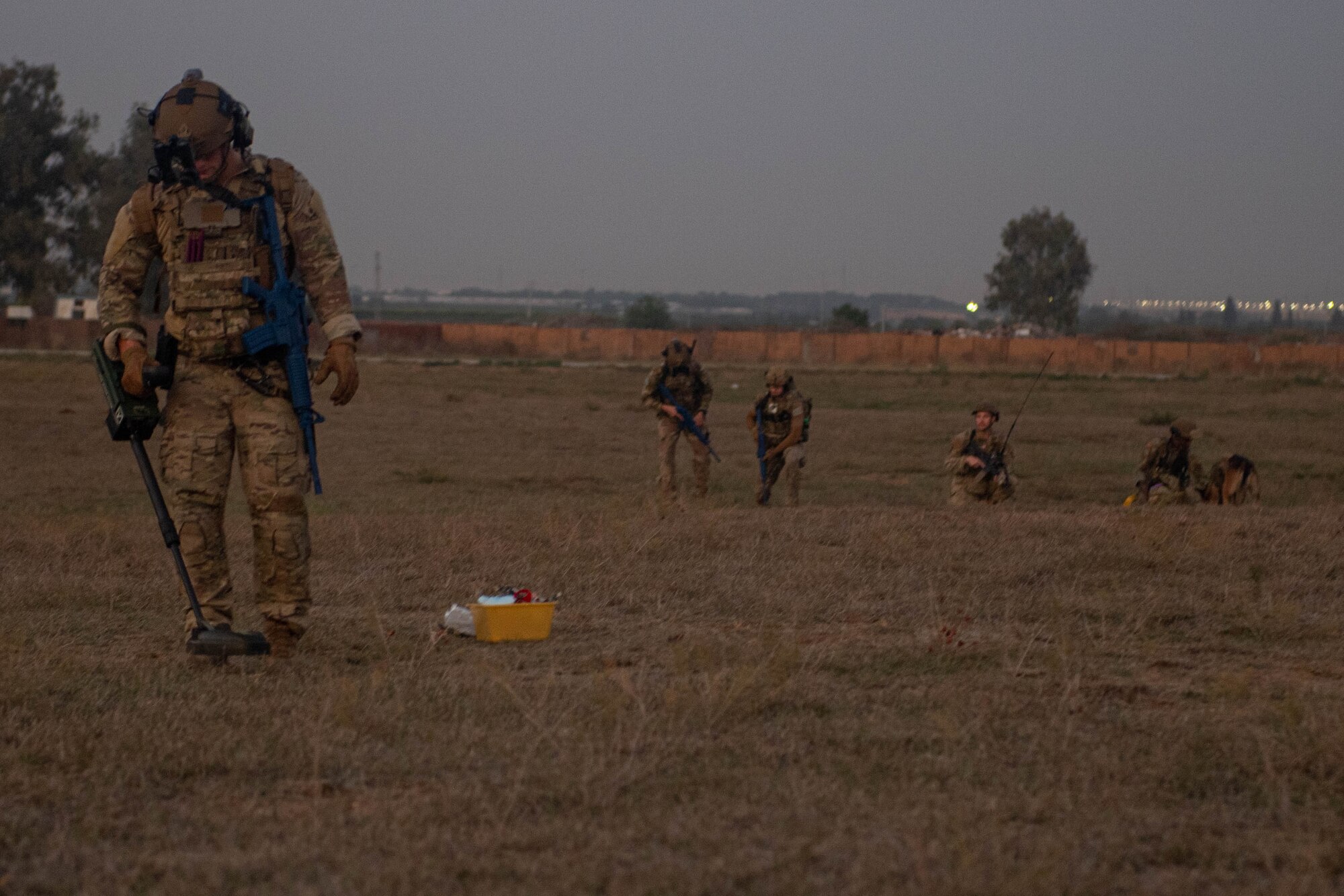 An EOD team member scans a field for a possible UXO during a joint training exercise