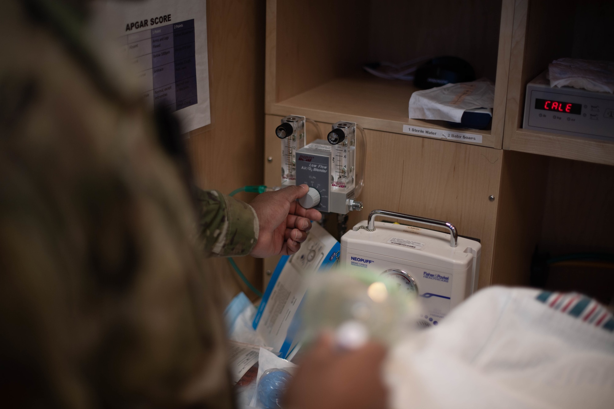 U.S. Air Force Staff Sgt. Lamaar Melvin, 86th Medical Squadron Labor and Delivery supervisor, adjusts the flow of oxygen through an infant oxygen mask to ensure it is in good condition at Landstuhl Regional Medical Center, Nov. 9, 2021. This piece of equipment is used to help give a newborn child oxygen in cases that the child has difficulty breathing. (U.S. Air Force photo by Airman Jared Lovett)