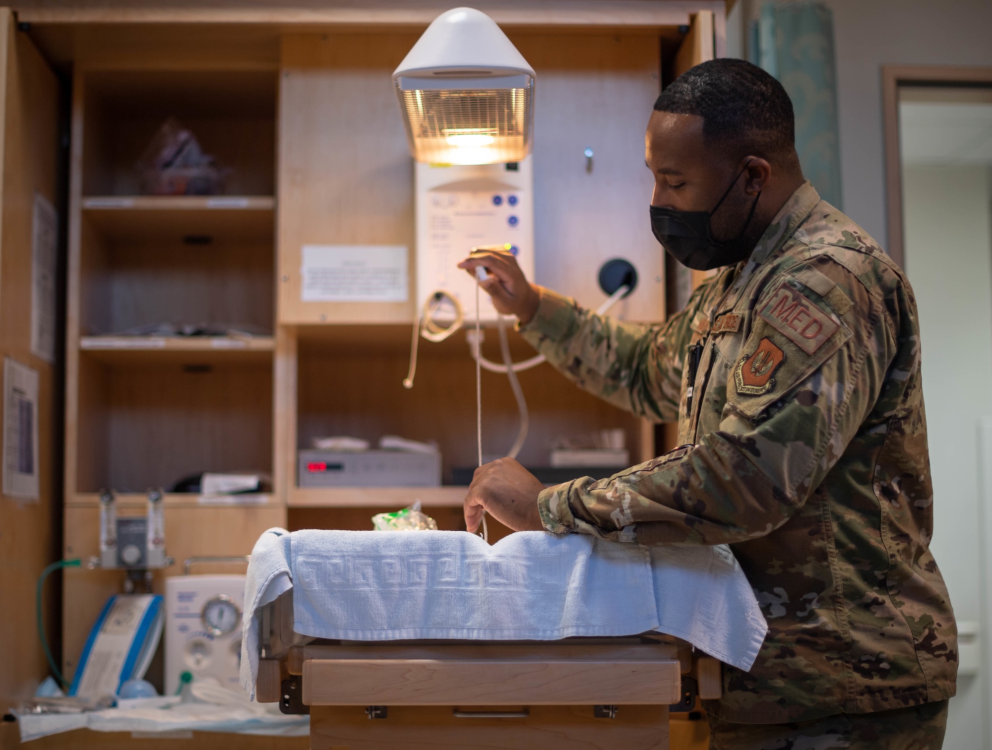 U.S. Air Force Staff Sgt. Lamaar Melvin, 86th Medical Squadron Labor and Delivery supervisor, prepares a neonatal warmer at the Landstuhl Regional Medical Center, Nov. 9, 2021. When a child is born at LRMC with health issues such as trouble breathing or is in overall poor condition, the child can be brought to the neonatal warmer where a practitioner can perform resuscitative measures, heat therapy, or assist the child’s breathing. (U.S. Air Force photo by Airman Jared Lovett)