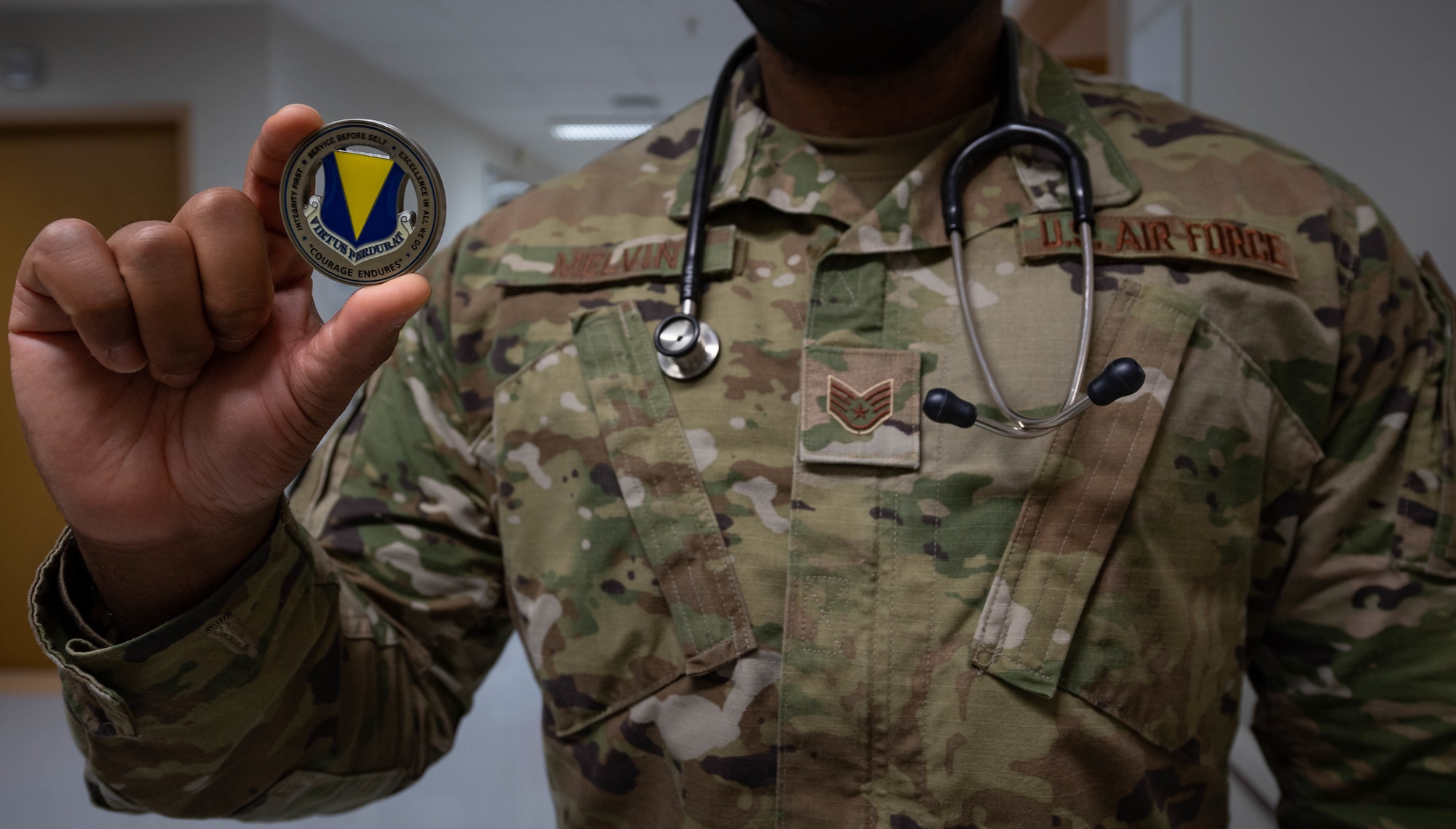 U.S. Air Force Staff Sgt. Lamaar Melvin, 86th Medical Squadron Labor and Delivery supervisor, holds the 86th Airlift Wing commander’s coin at the Landstuhl Regional Medical Center, Nov. 9, 2021. Melvin was presented with the commander’s coin for his outstanding work during the Afghanistan evacuation operations at Ramstein Air Base, Germany, Aug. 21, 2021, when he aided in the delivery of a child on the ramp of a C-17 Globemaster lll aircraft. (U.S. Air Force photo by Airman Jared Lovett)