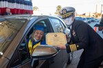 Norfolk Naval Shipyard Commander, Capt. Dianna Wolfson, presents Apprentice Program Class of 2021 valedictorian Allyson Cross, A Shop 89 Fabric Worker Mechanic, her diploma during a drive thru gradation, Nov. 23.