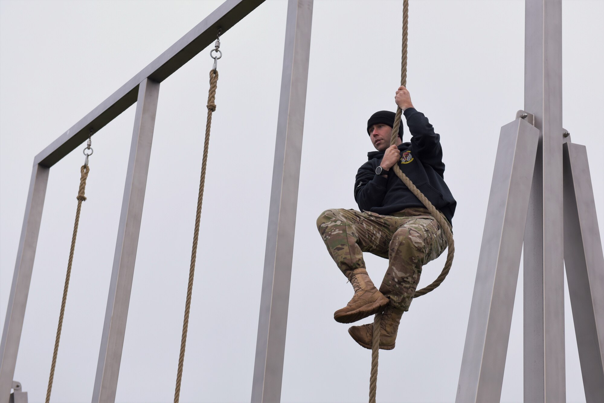 Man climbs a rope