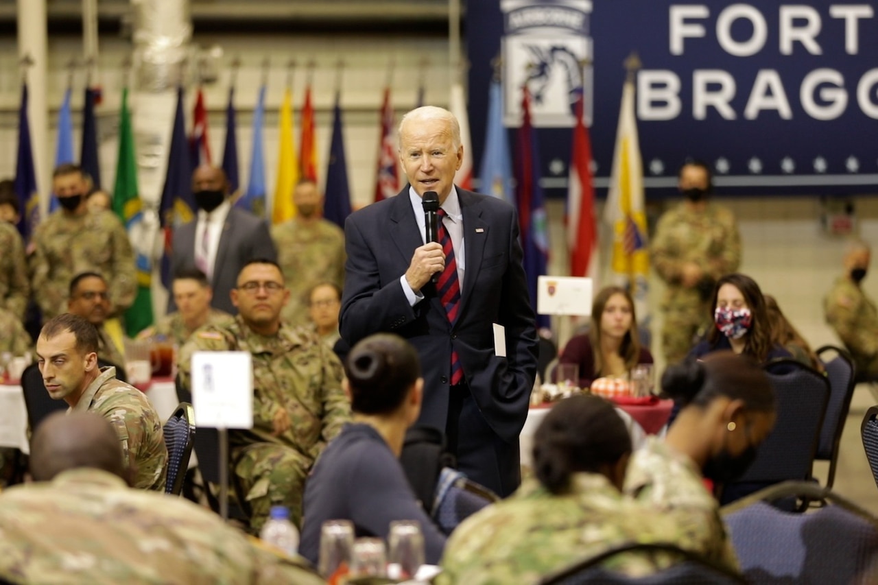 President Joe Biden speaks to soldiers .