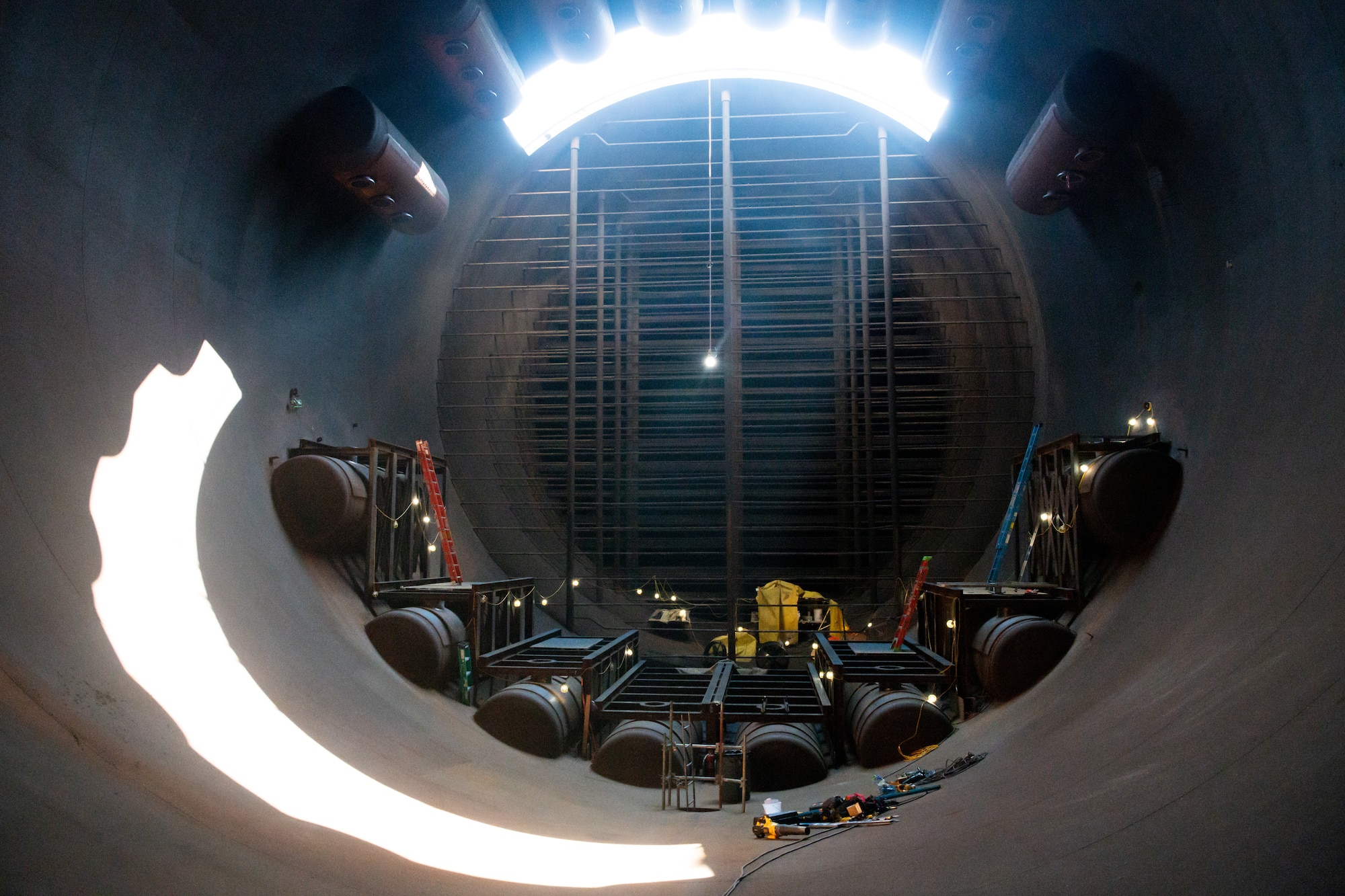 Heat exchangers will be installed on the framework, shown in this image taken Sept. 14, 2021, at Arnold Air Force Base, Tenn., inside of exhaust cooler 1 of the Aeropropulsion Systems Test Facility to increase the volume of exhaust that can be cooled in the time it takes for it to flow from the test cells to the exhausters. The heat exchangers are part of the Next Generation Turbine Engine Test Capability project to restore capability lost through aging of the facility and increase capability. The hole shown in the top of the duct was cut to allow installation of the heat exchangers. (U.S. Air Force photo by Jill Pickett)