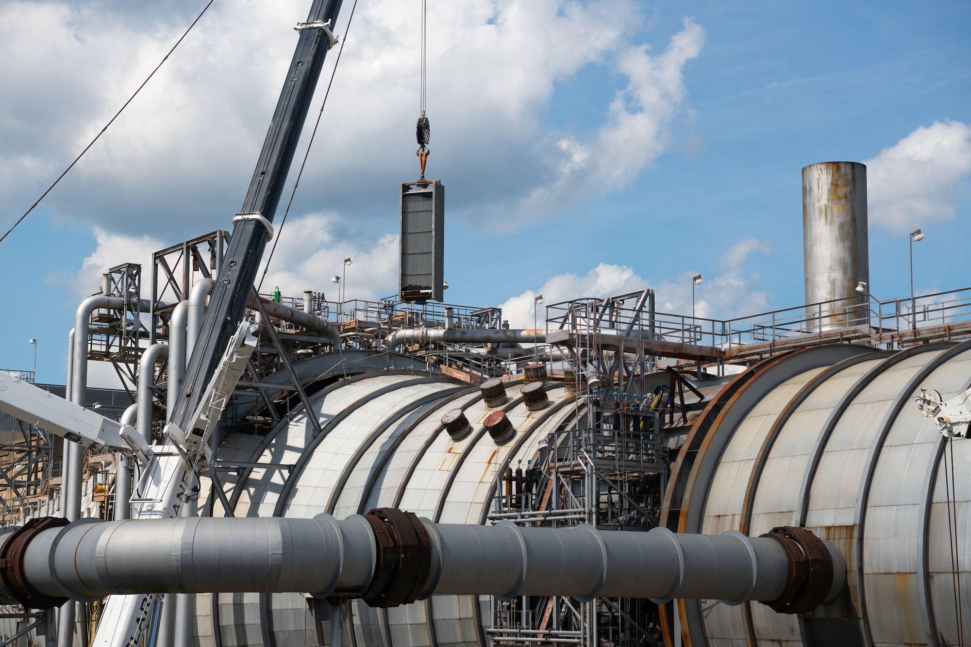 A heat exchanger is lifted and lowered into exhaust cooler 1 of the Aeropropulsion Systems Test Facility at Arnold Air Force Base, Tenn., Sept. 29, 2021. (U.S. Air Force photo by Jill Pickett)