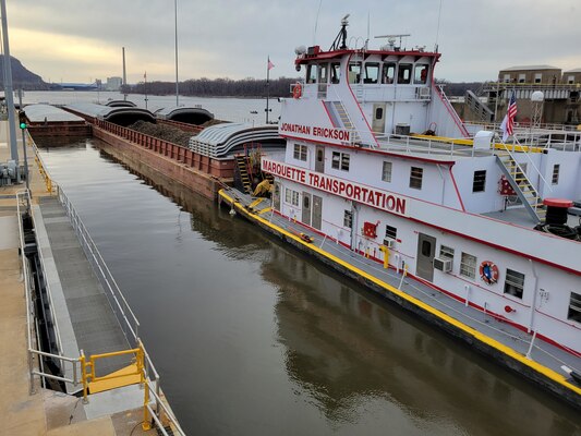 A motor vessel pushing barges on a river.