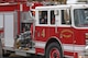 Makai Barker, Hanscom Middle School student, waves to classmates as he arrives to school in a fire truck at Hanscom Air Force Base, Mass., Nov. 19.