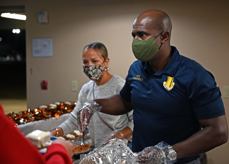 U.S. Air Force Col. James Finlayson, 17th Training Wing vice commander, serves food to students during a Thanksgiving event at the Crossroads on Goodfellow Air Force Base, Texas, Nov. 23, 2021. Finlayson and other leaders came together to show the students their appreciation for their service. (U.S. Air Force photo by Senior Airman Michael Bowman)