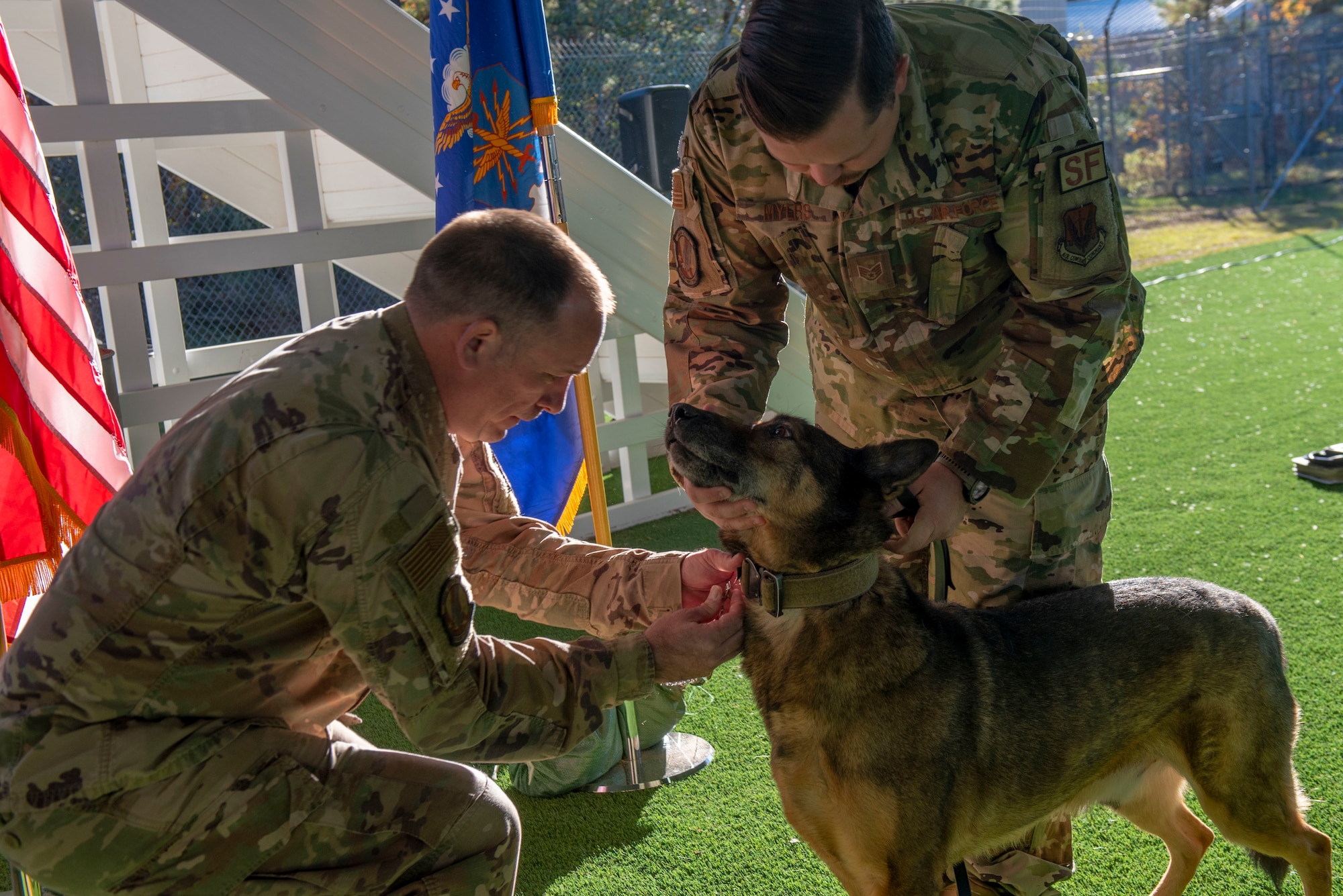 A MWD receives a medal as part of a retirement ceremony.