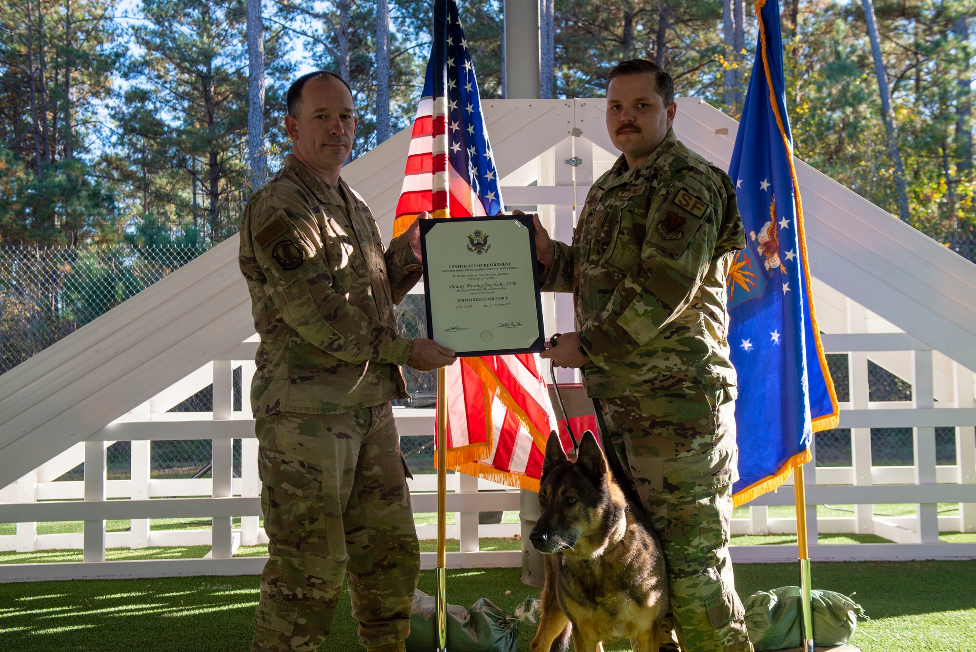 A MWD receives a certificate from leadership as part of a retirement ceremony.