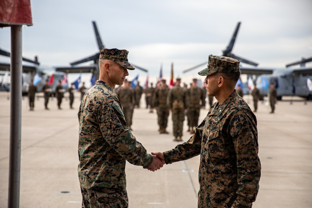 U.S. Marine Corps Lt. Col. Ricky D. Buria, (right), incoming commanding officer of Marine Medium Tiltrotor Squadron (VMM) 362, Marine Aircraft Group (MAG) 16, 3rd Marine Aircraft Wing (MAW), shakes hands with Lt. Col. Clark T. Purcell, outgoing commanding officer during the VMM-362 change of command ceremony at Marine Corps Air Station Miramar, Calif., Nov. 23, 2021. The ceremony was held to relinquish the command from Purcell to Buria. (U.S. Marine Corps photo by Sergeant Samuel Ruiz)