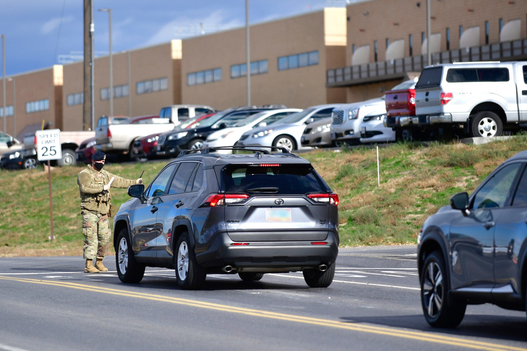 A vehicle is directed to pull over by a Defender.