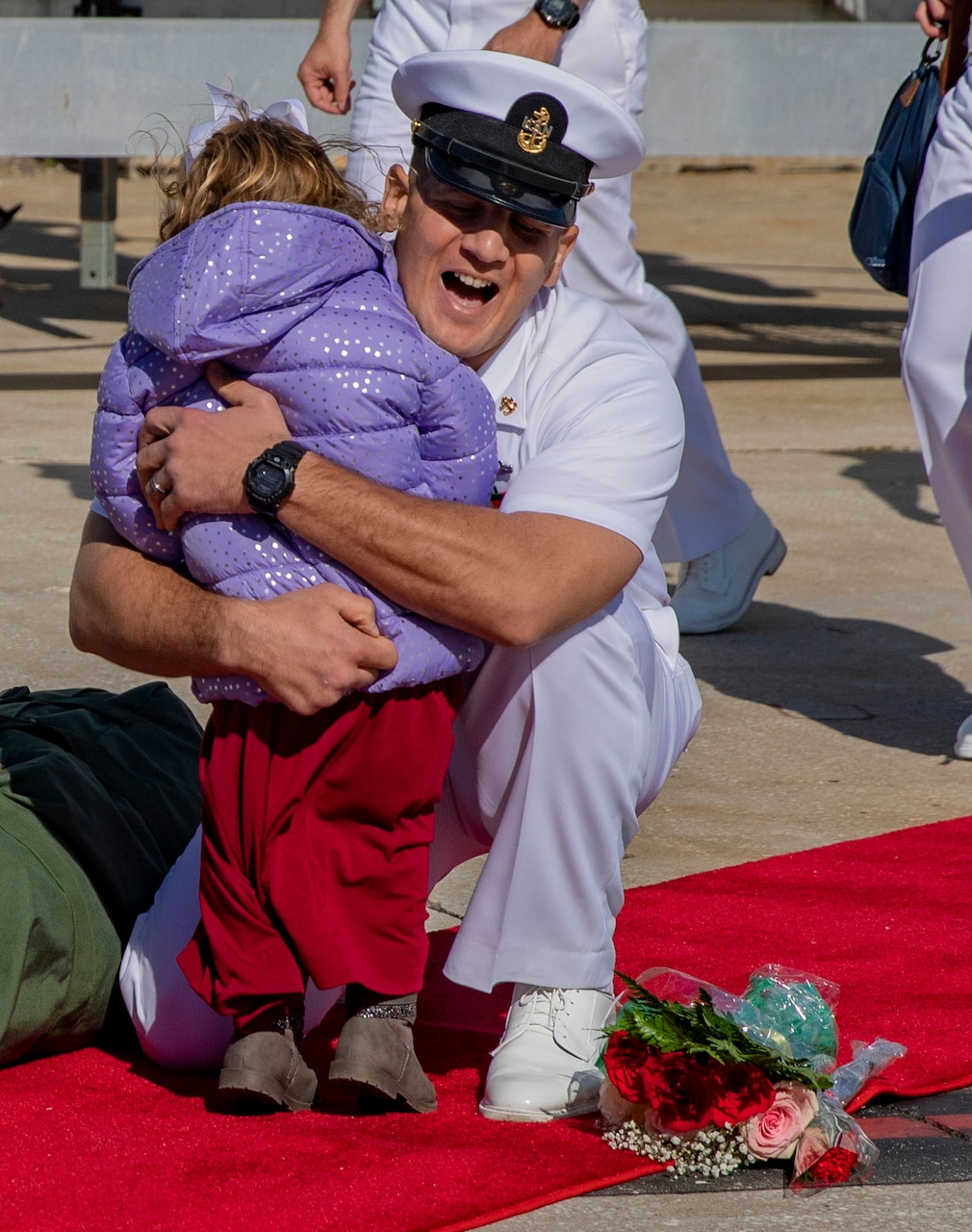 A chief petty officer, assigned to the Arleigh Burke-class guided-missile destroyer USS The Sullivans (DDG 68), greets his family after returning from a seven-month world deployment with the United Kingdom's HMS Queen Elizabeth (R08) Carrier Strike Group, Nov. 24, 2021.