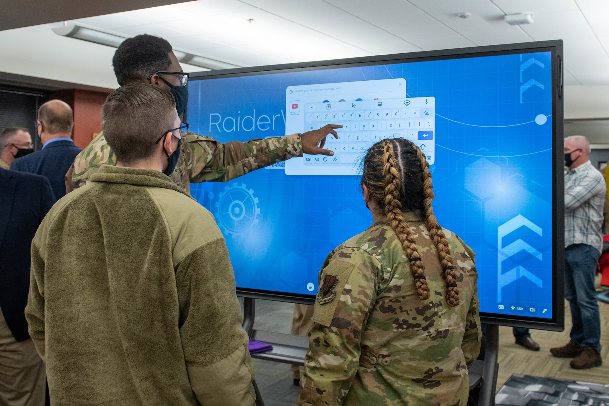 Airmen use a touchscreen during the opening ceremony for Raiderwerx at Ellsworth Air Force Base, S.D., Nov. 19, 2021. Raiderwerx is a public space that is open for the entire Ellsworth community to use and explore 24 hours a day (U.S. Air Force photo by Senior Airman Quentin Marx)