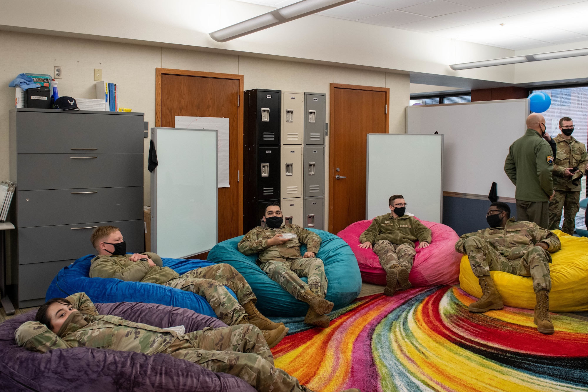 Airmen sit in bean bag chairs during the Raiderwerx open house and ribbon cutting event at Ellsworth Air Force Base, S.D., Nov. 19, 2021. Raiderwerx is led by a group of volunteers and active innovators from across the Ellsworth community. (U.S. Air Force photo by Senior Airman Quentin Marx)